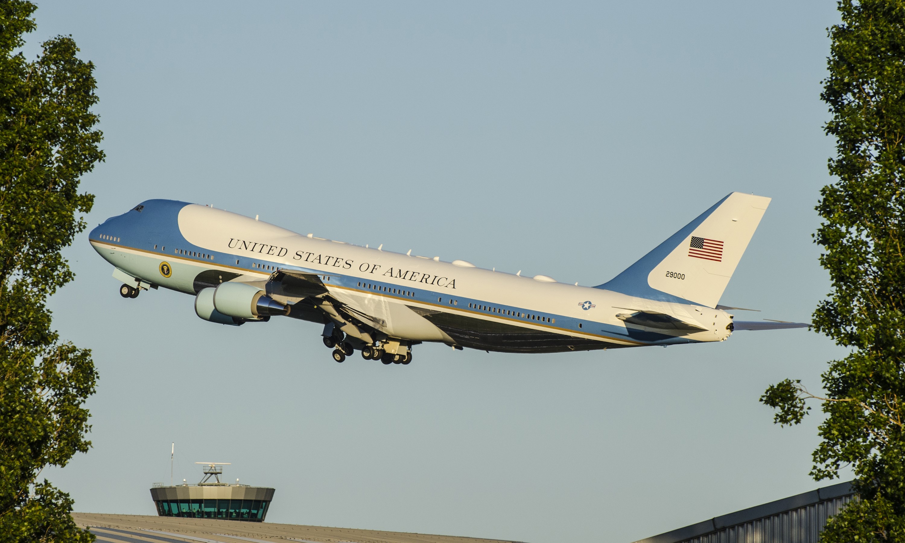 Air Force One taking off near an airport control tower HD Wallpaper