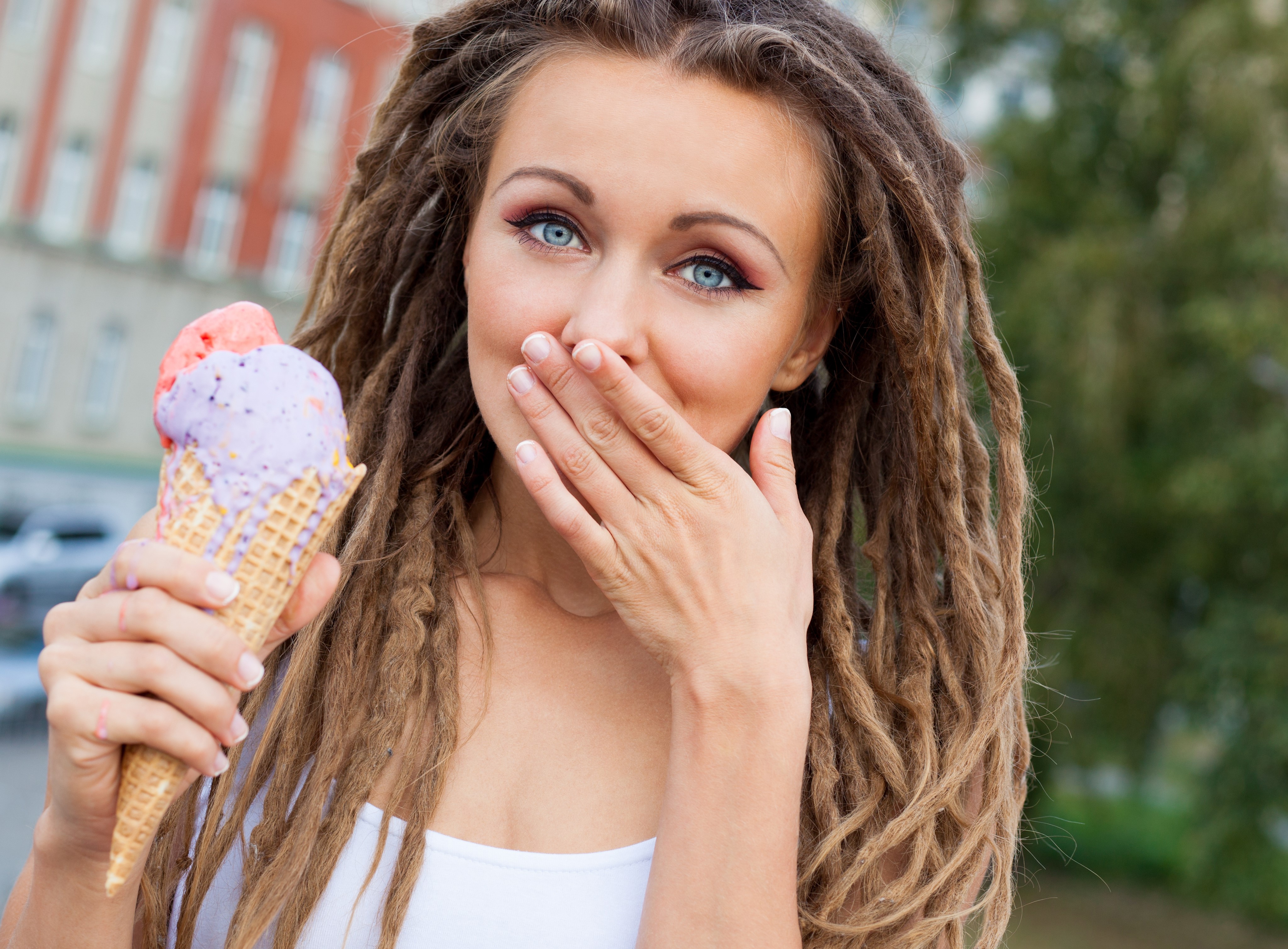 Woman with dreadlocks eating ice cream HD Wallpaper