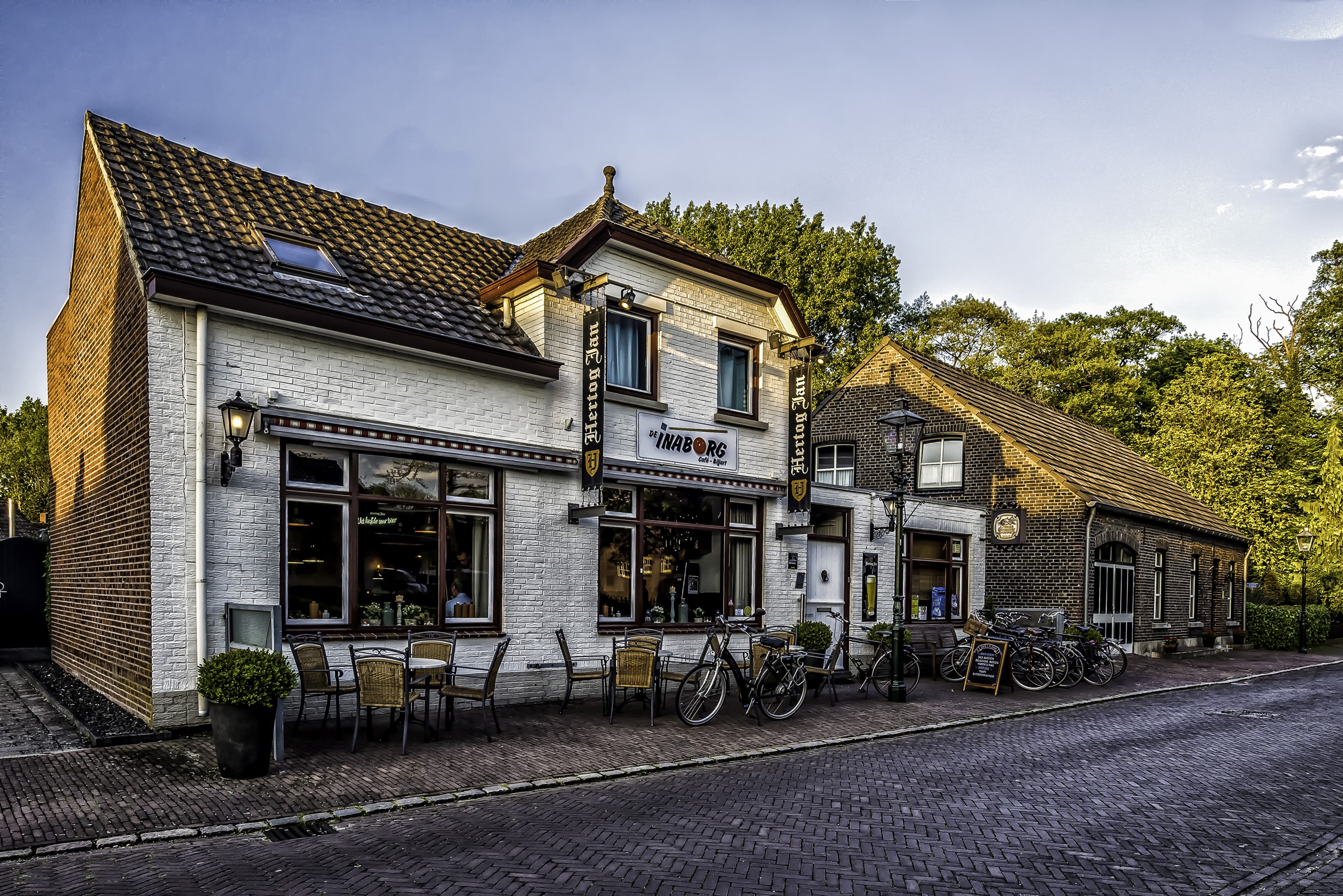 Hertog Jan Inn building with bicycles on street in Arcen, Netherlands HD Wallpaper