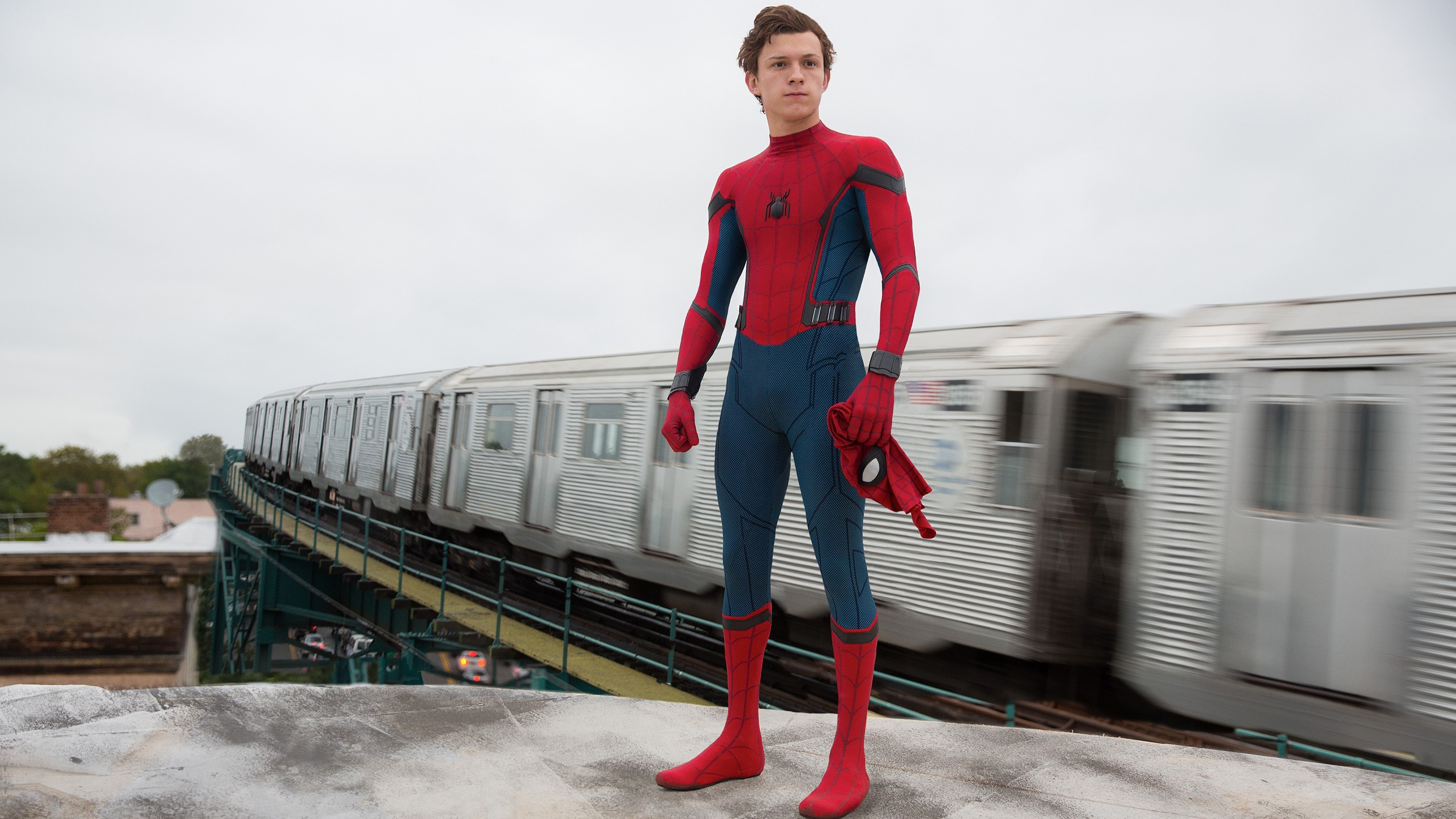 Spider-Man (Tom Holland) on a rooftop with a train HD Wallpaper