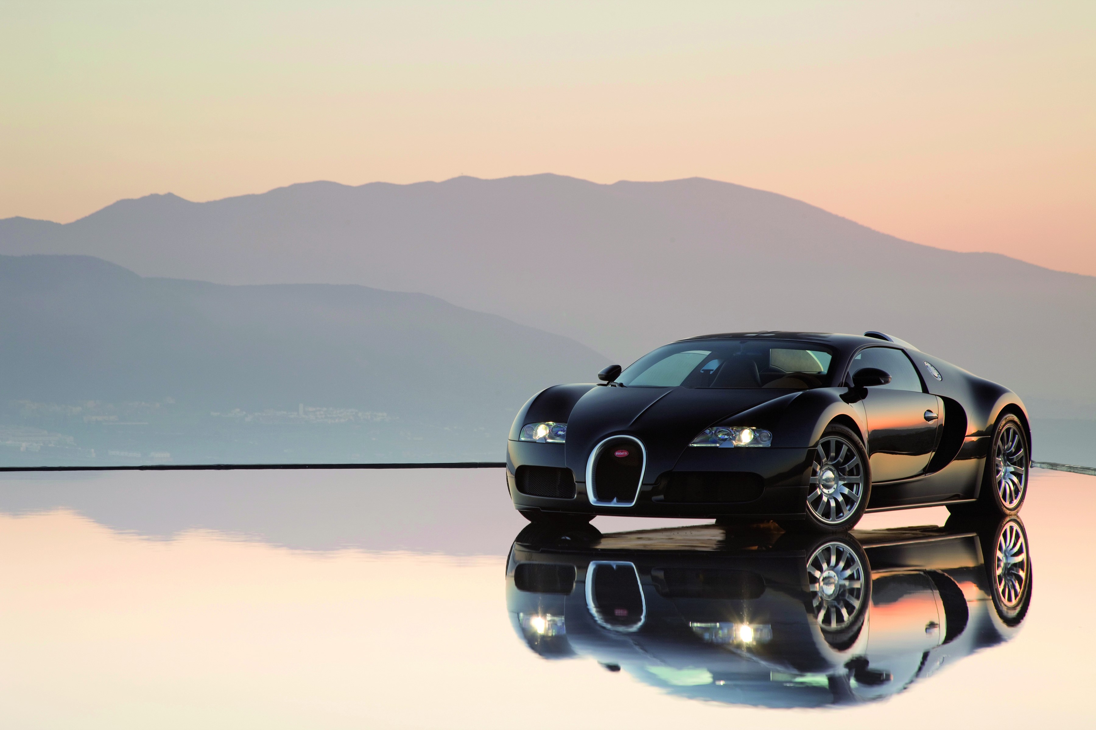 Black Bugatti Veyron on reflective surface with mountains HD Wallpaper