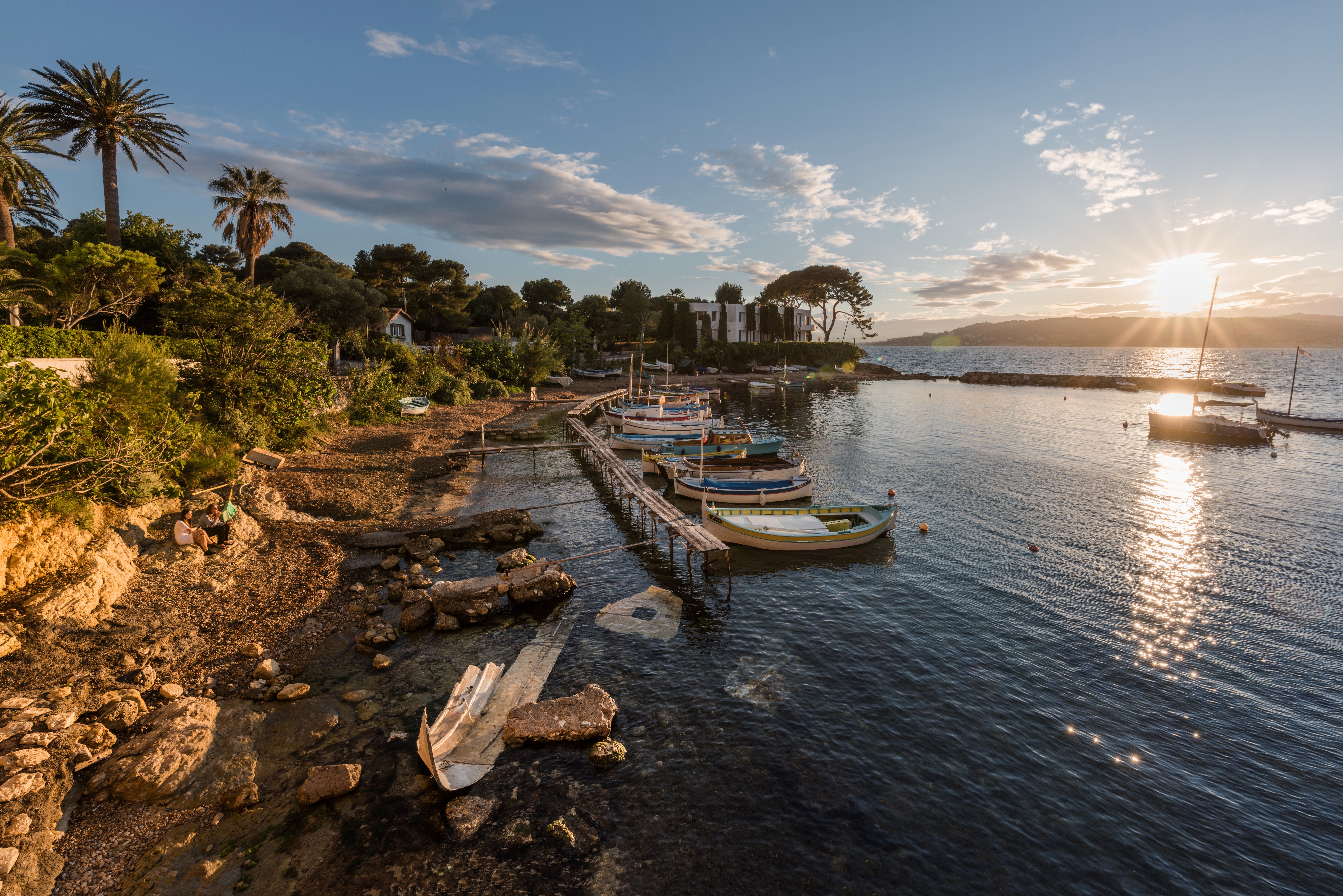 Boats docked at a pier in Antibes, France at sunset HD Wallpaper
