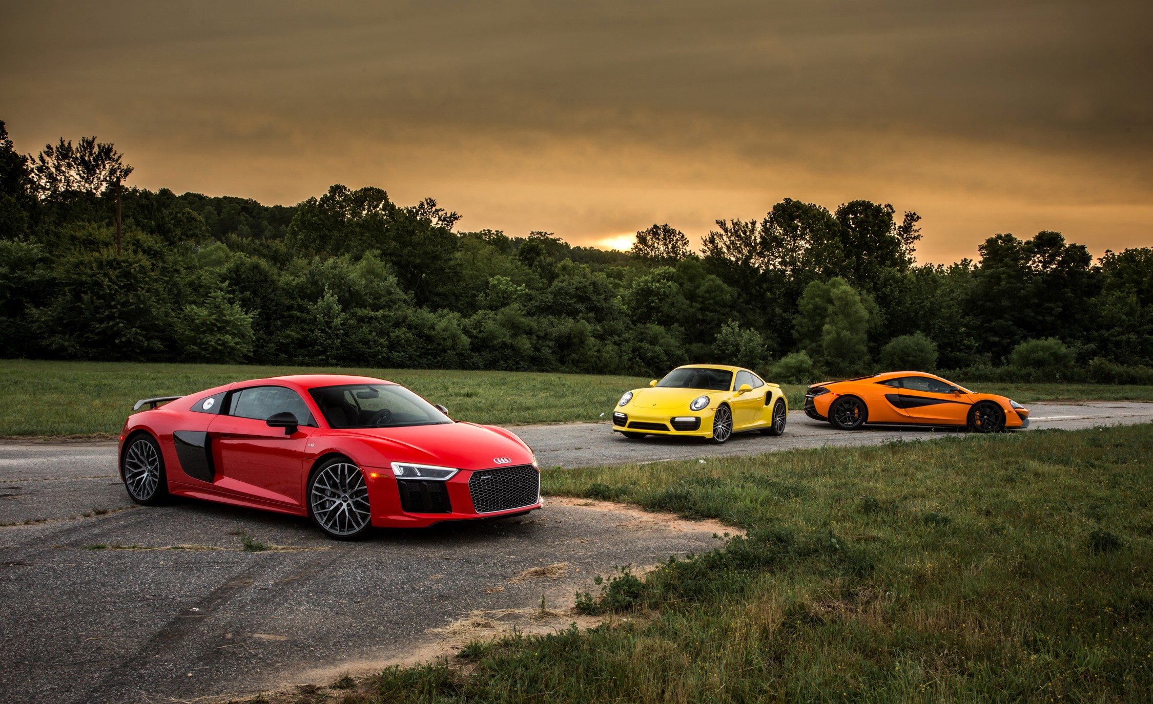 Red Audi R8, yellow Porsche, and orange McLaren sports cars HD Wallpaper