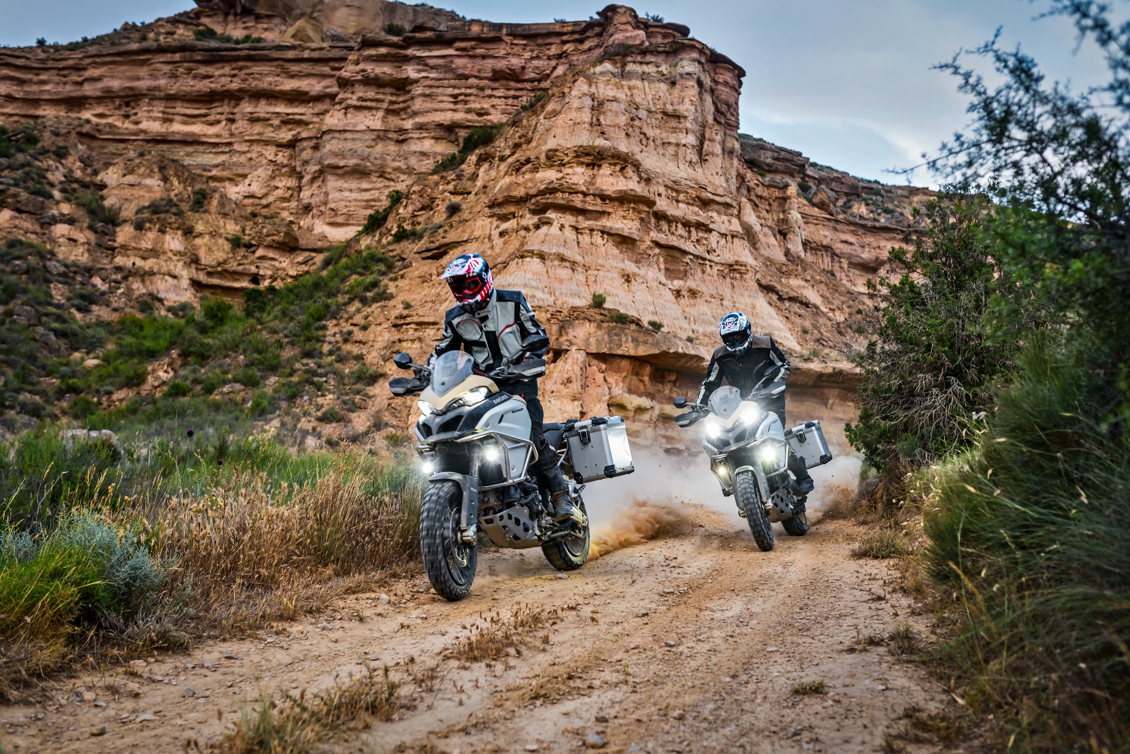 Two Ducati Multistrada 1200 Enduro Pro motorcycles on a dirt road HD Wallpaper