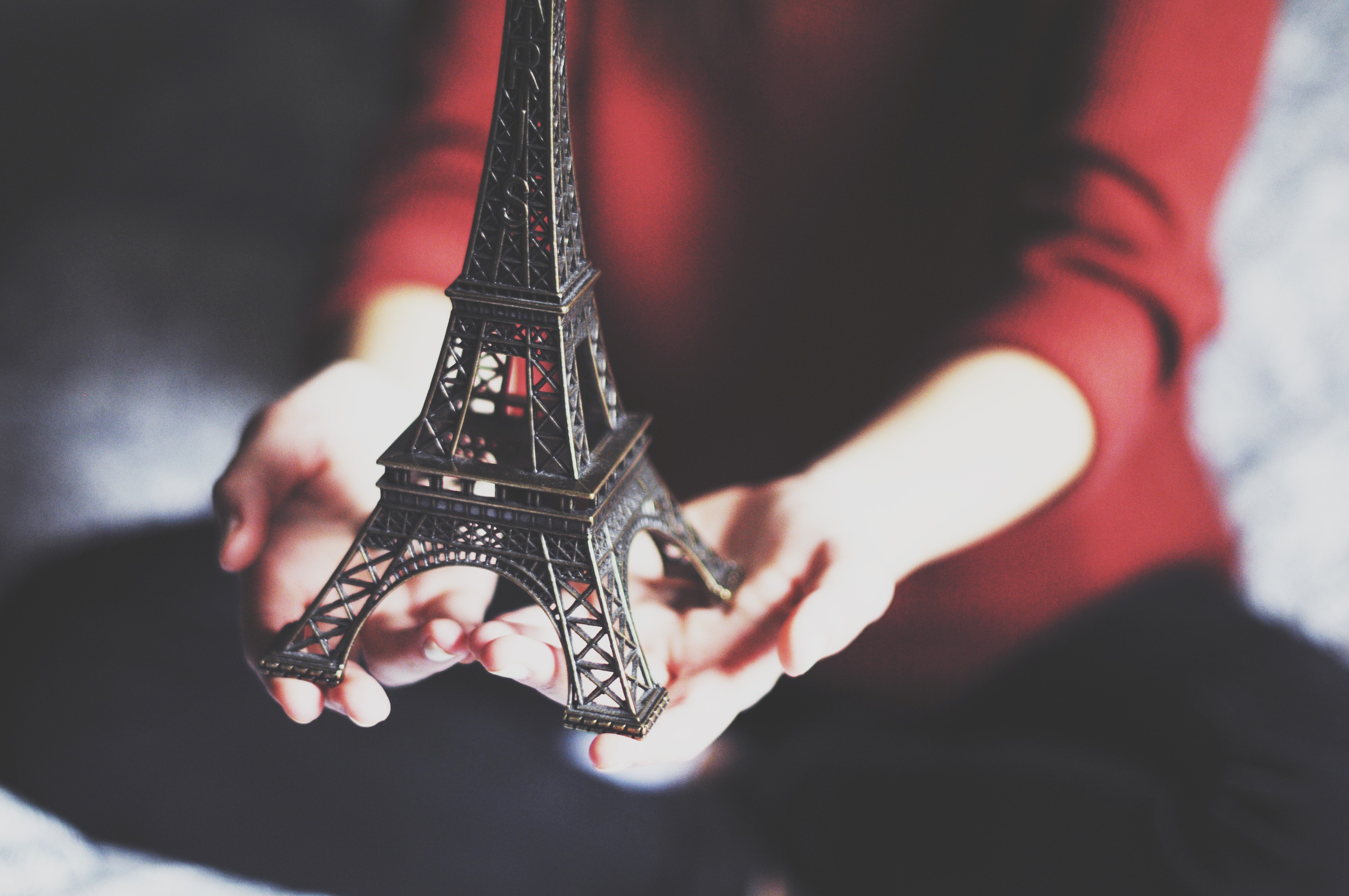Eiffel Tower souvenir held in hands HD Wallpaper