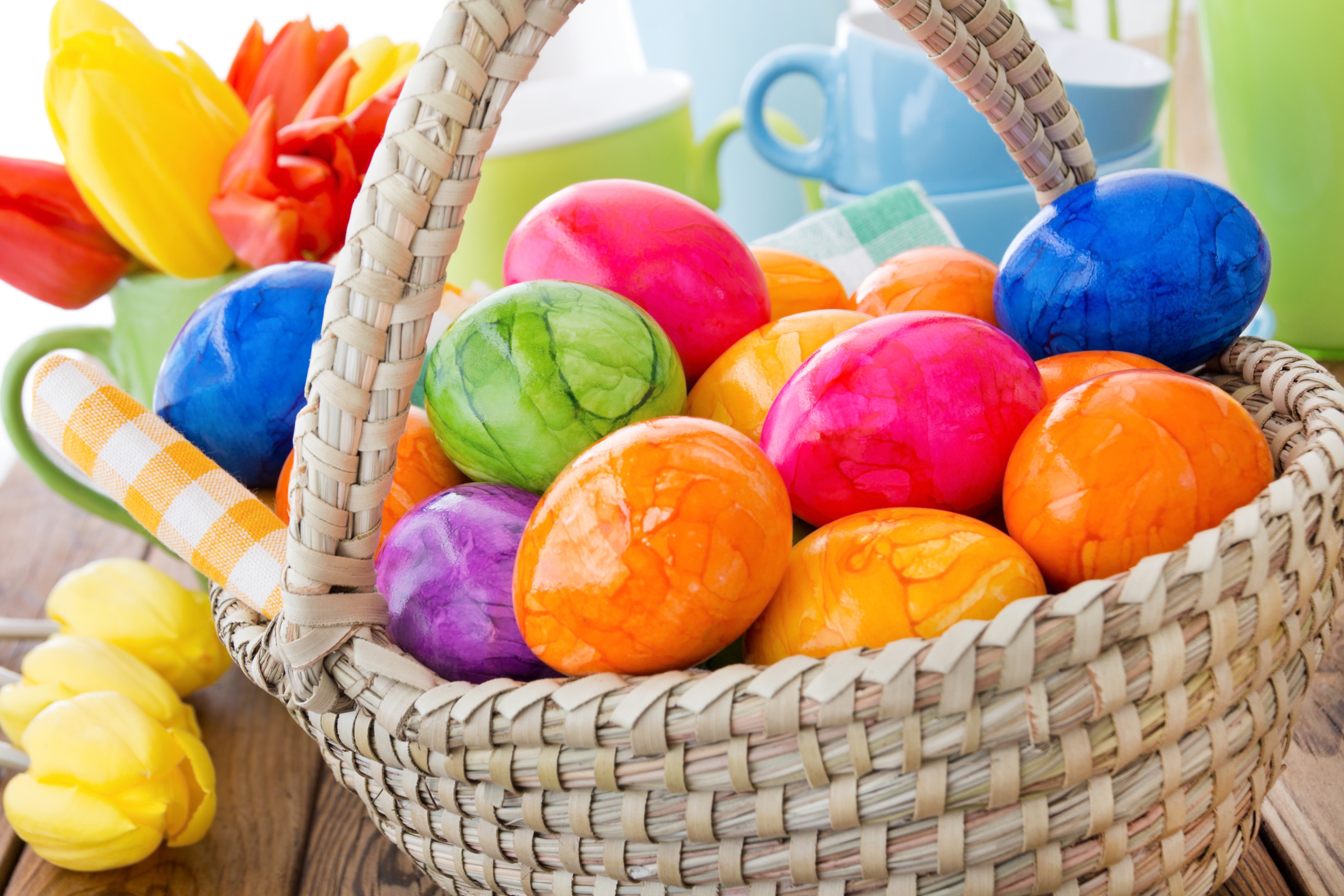 Easter eggs in a wicker basket with tulips HD Wallpaper