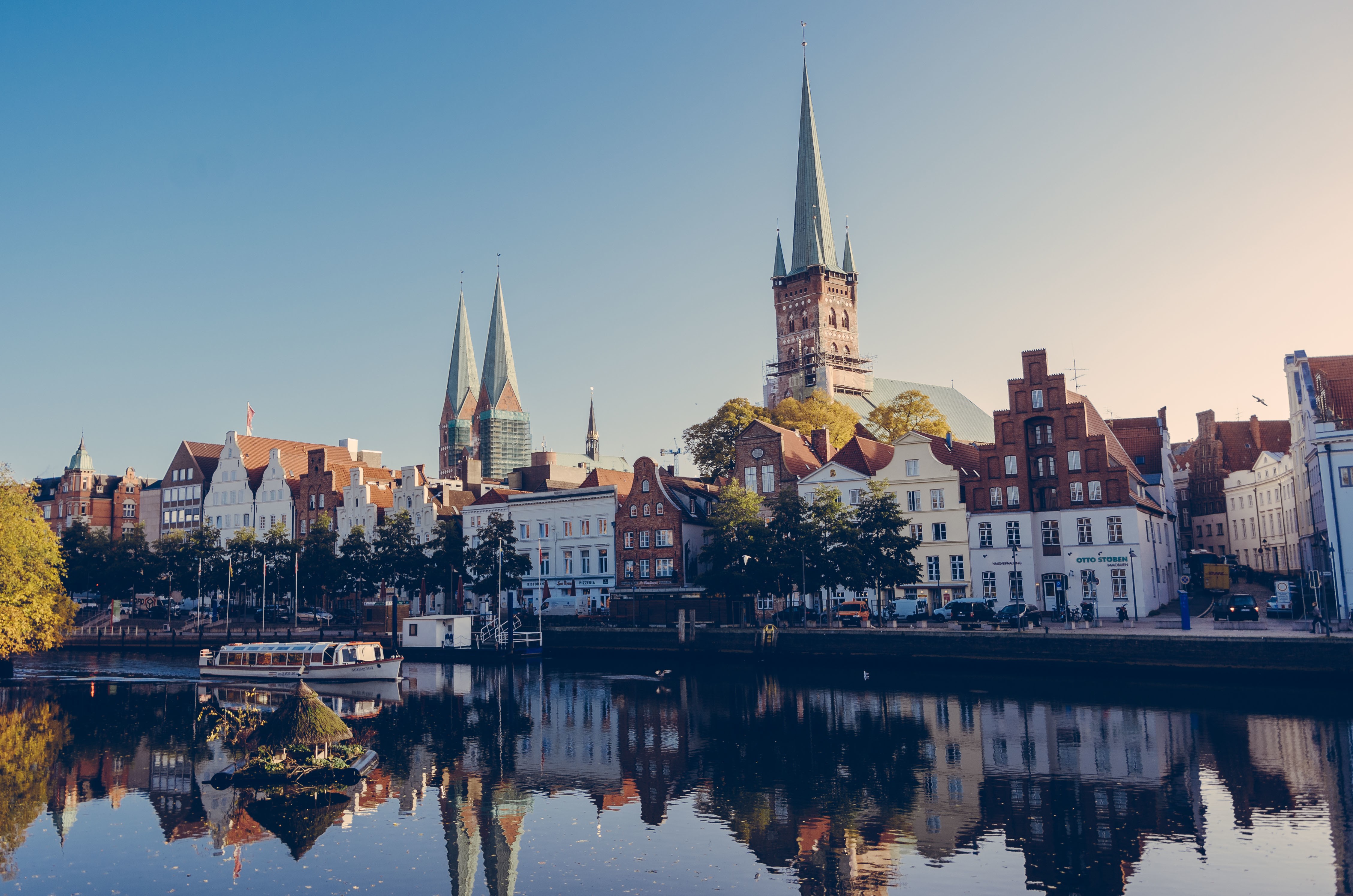 Riverfront buildings and churches in Lubeck, Germany HD Wallpaper