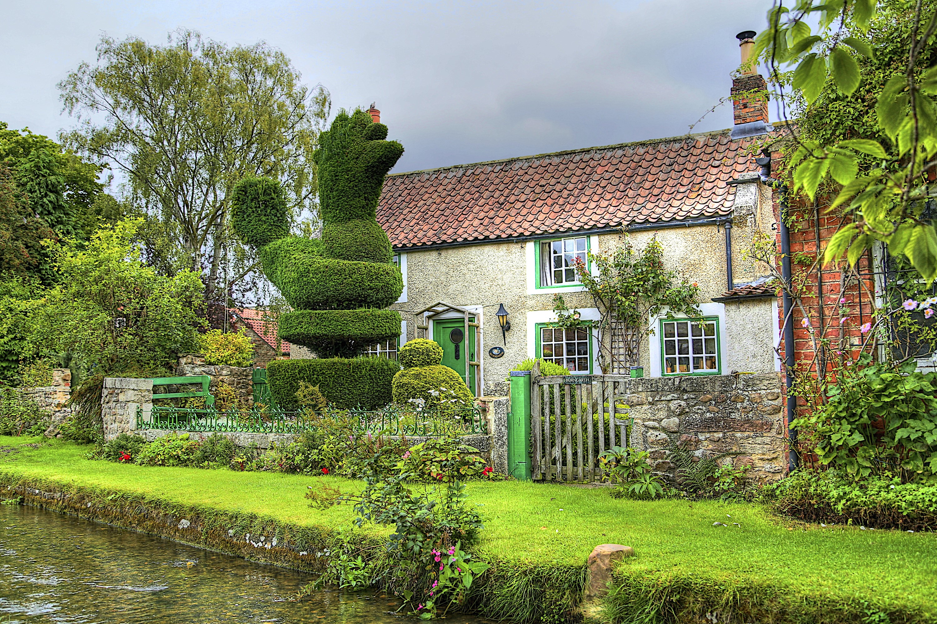 Topiary duck in front of a cottage in Bishop Monkton, England HD Wallpaper