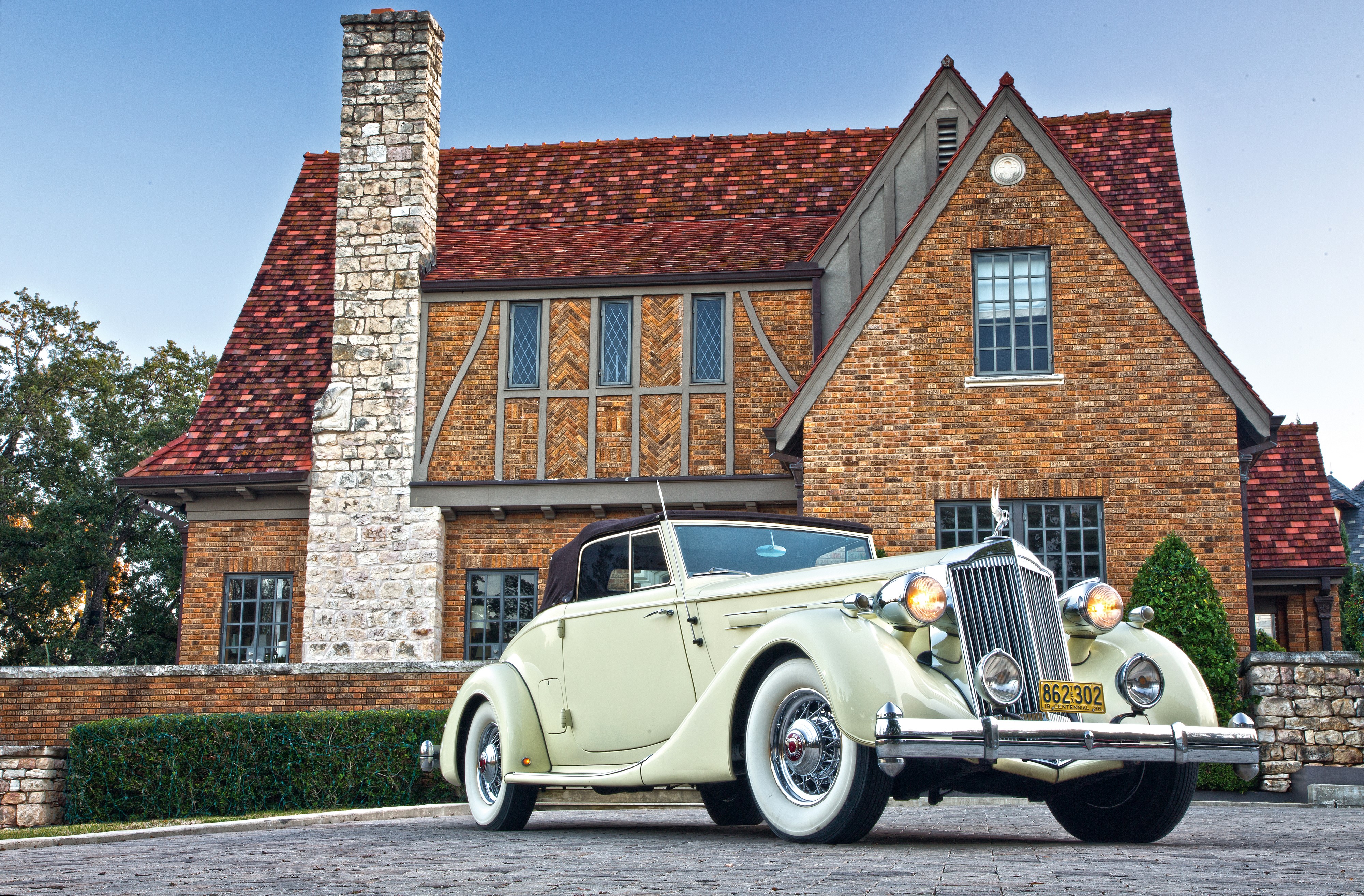 1936 Packard Twelve Coupe Roadster in front of a brick house HD Wallpaper