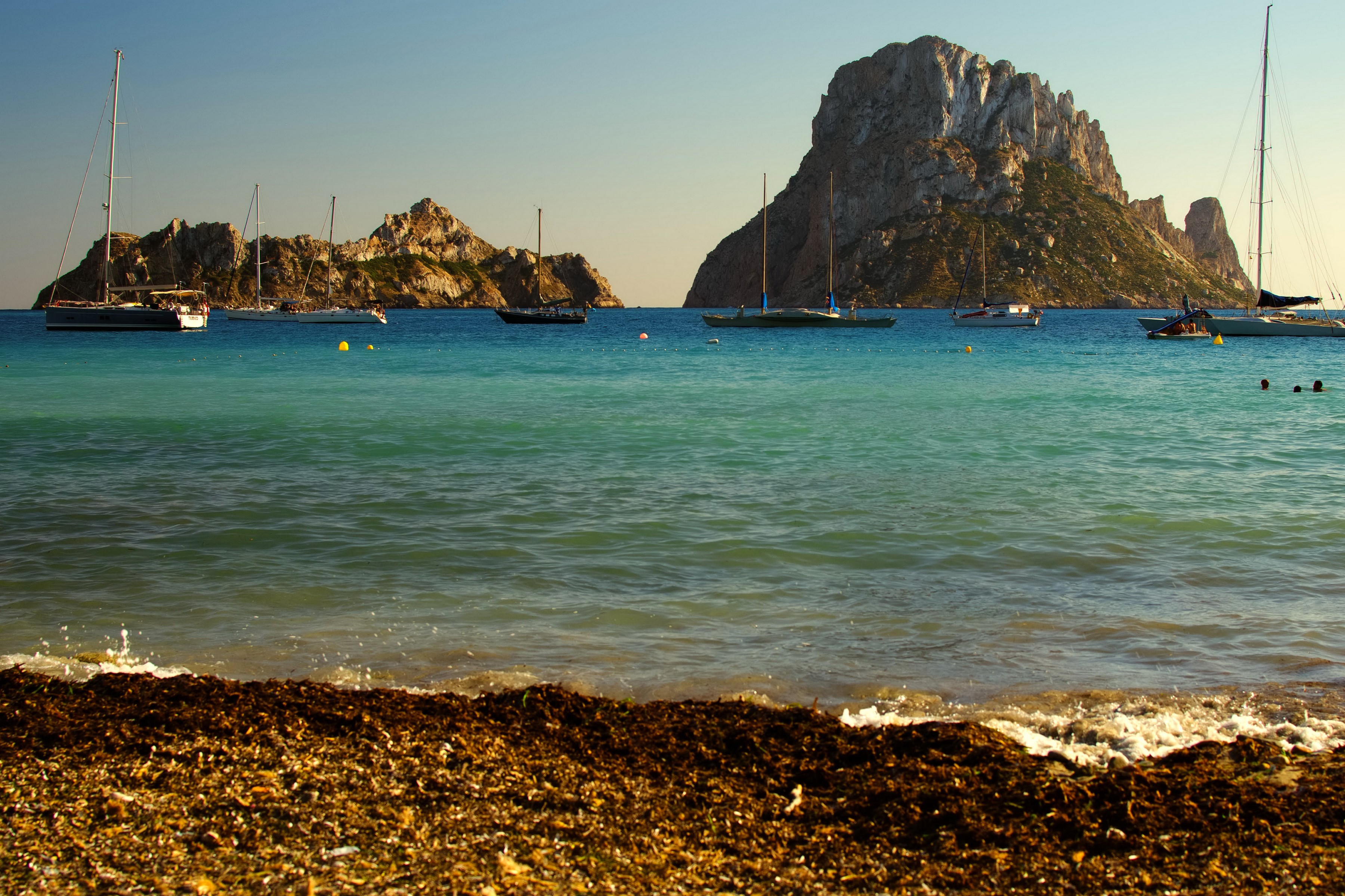 Sailboats in a bay near rocky islands, Ibiza, Spain HD Wallpaper