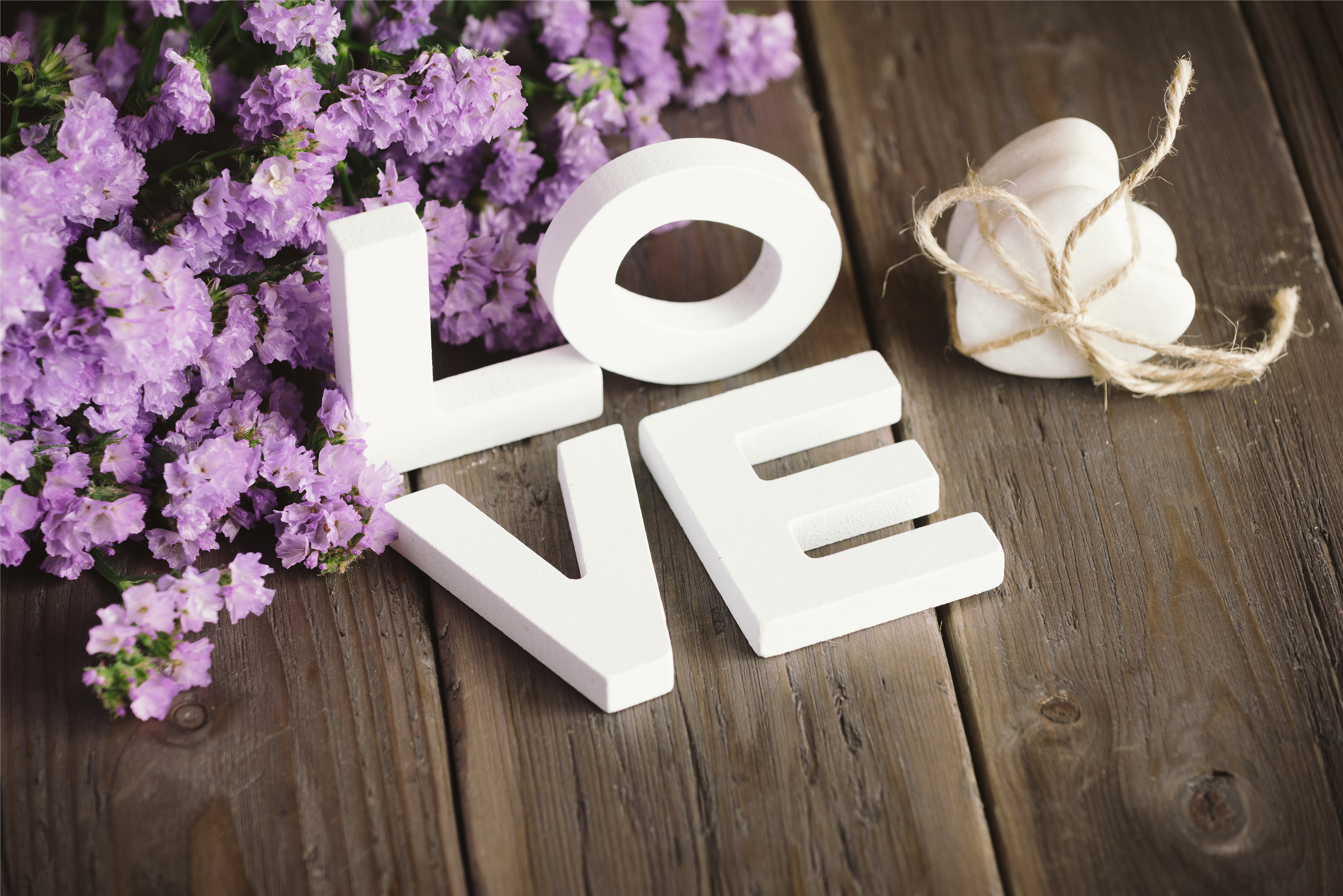Love spelled out with white letters and purple flowers HD Wallpaper