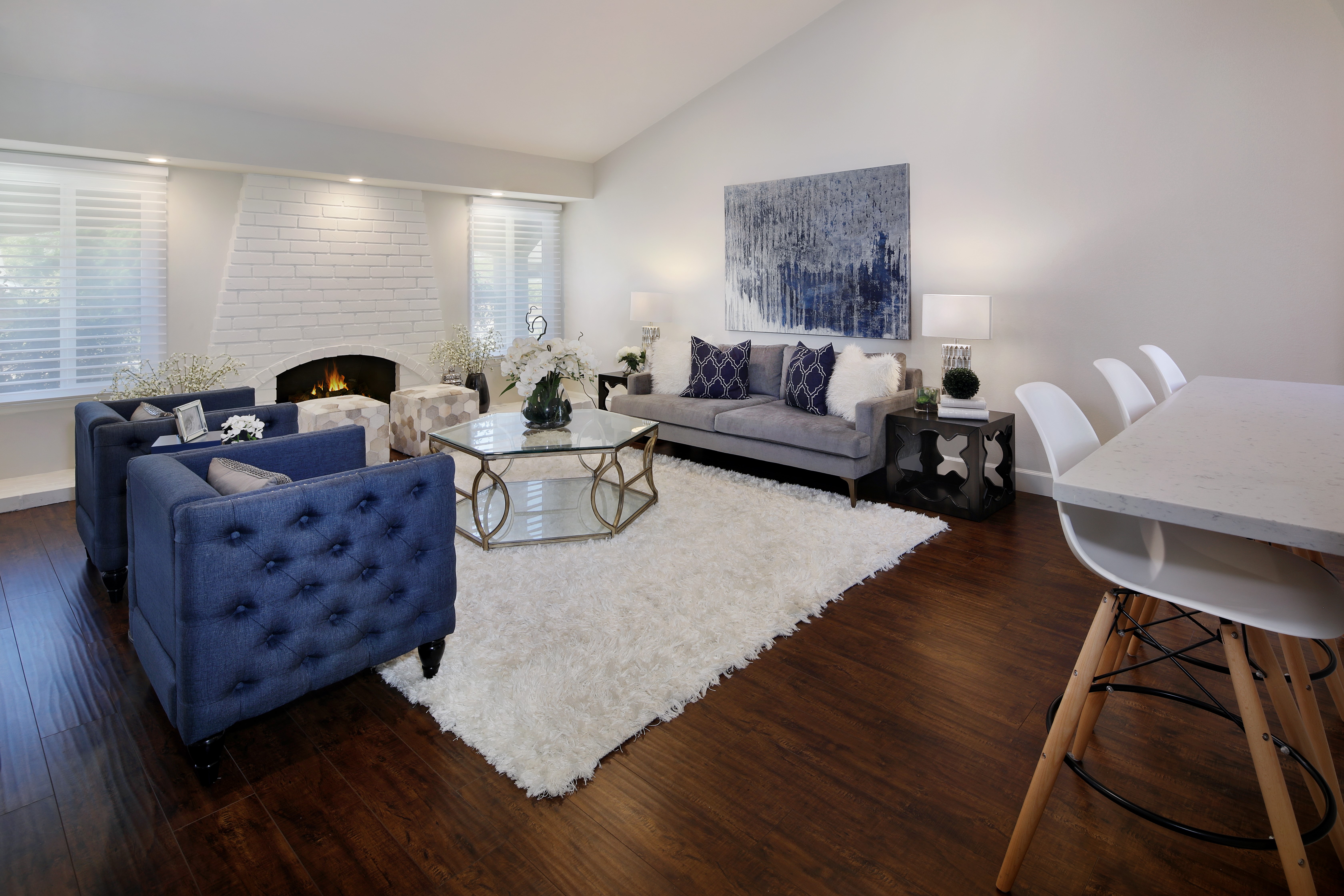 Living room with blue armchairs, gray sofa, and fireplace HD Wallpaper