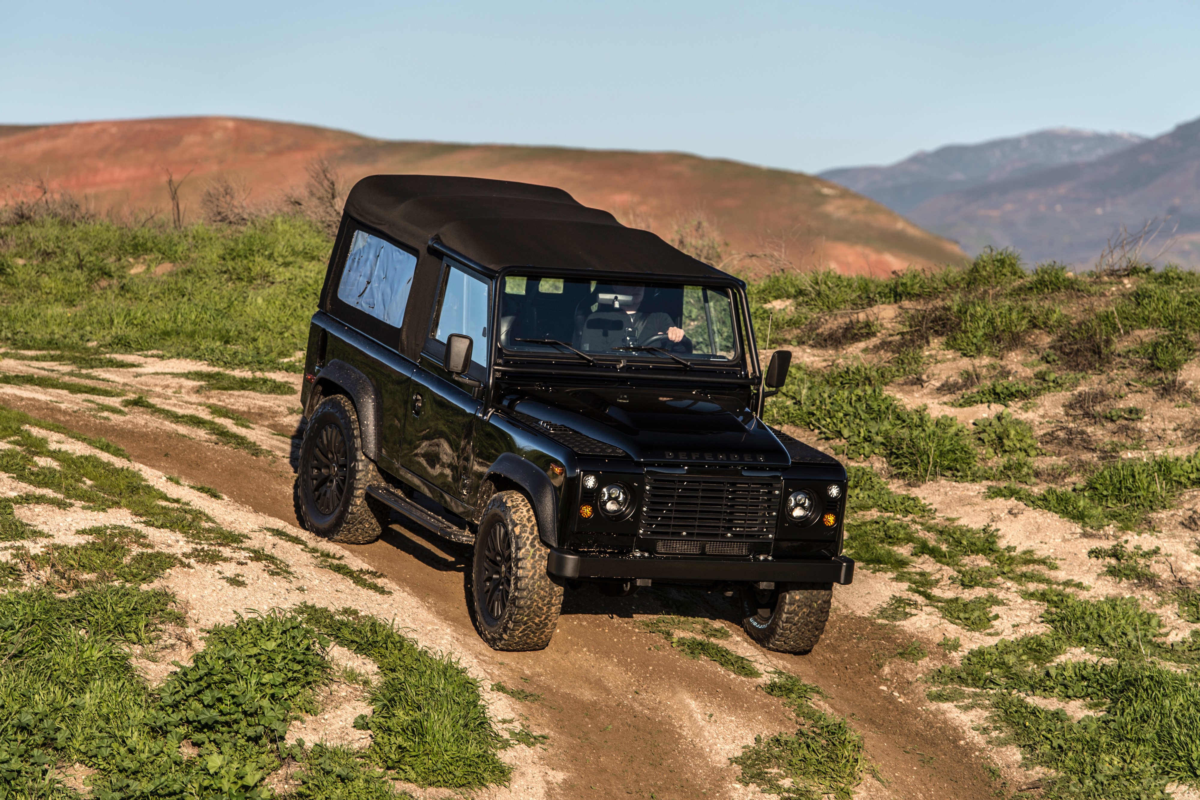 4K Black Land Rover Defender on Dirt Road HD Wallpaper
