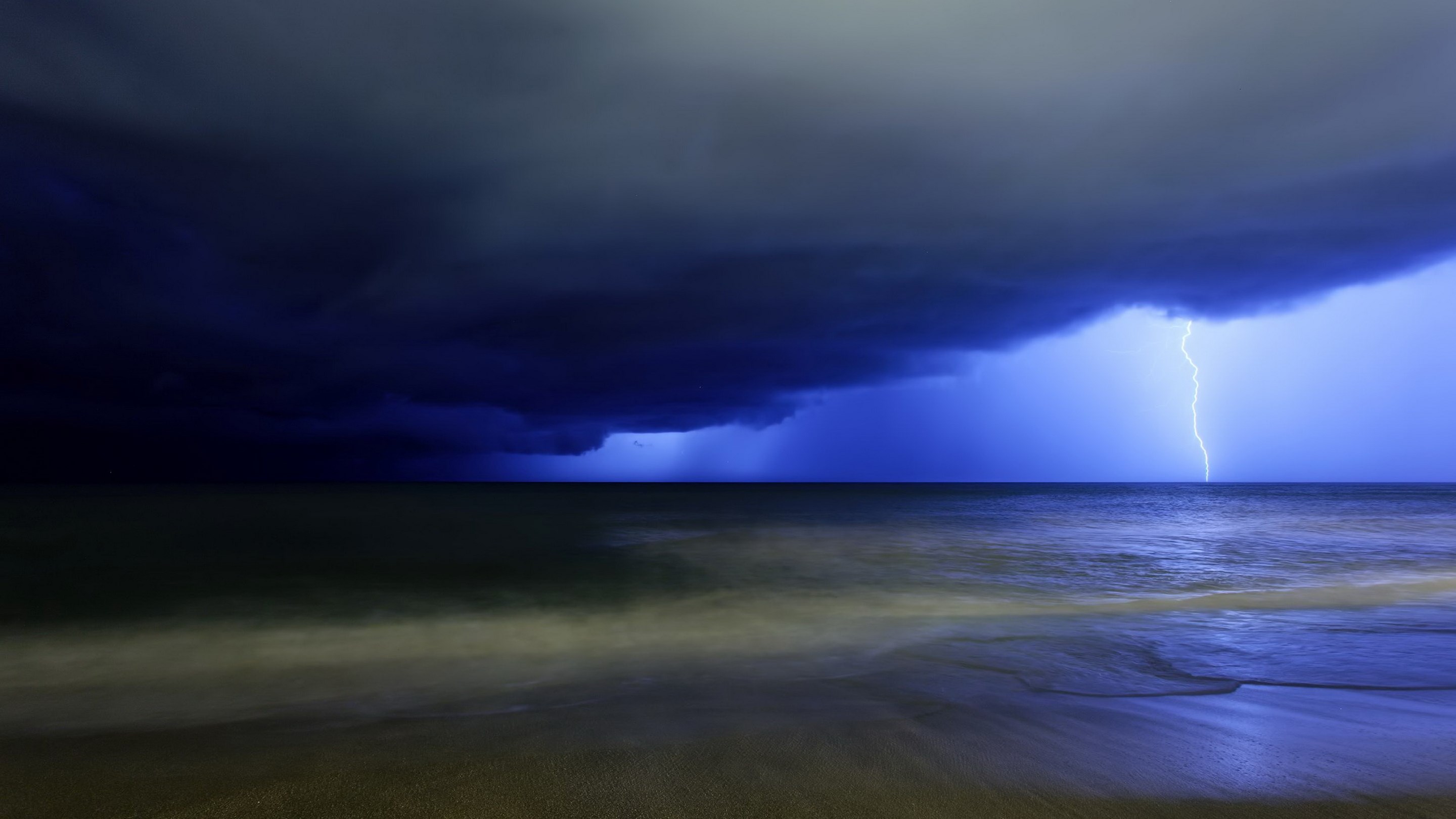 Lightning strike over the ocean during a storm HD Wallpaper