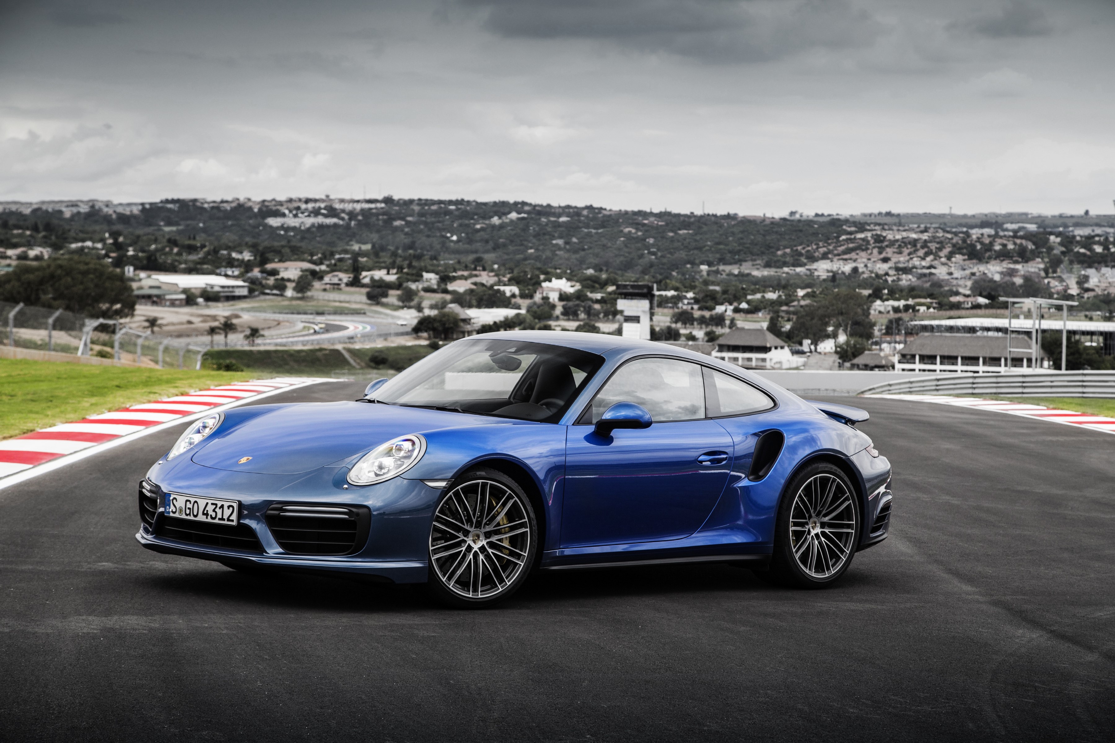 Blue Porsche 911 Turbo S Coupe on a Racetrack HD Wallpaper