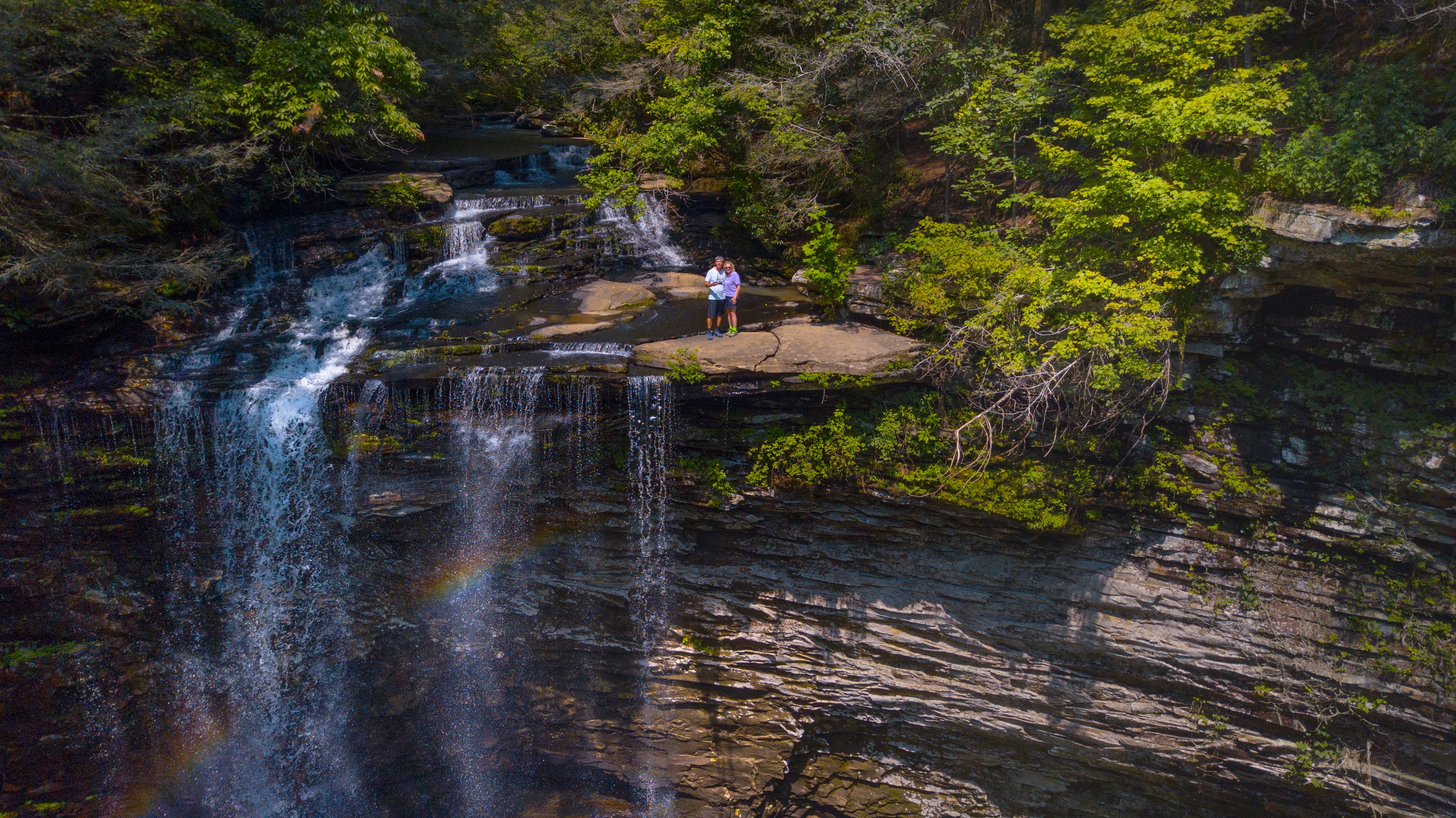 Couple standing on rocks at Piney Falls, Tennessee HD Wallpaper