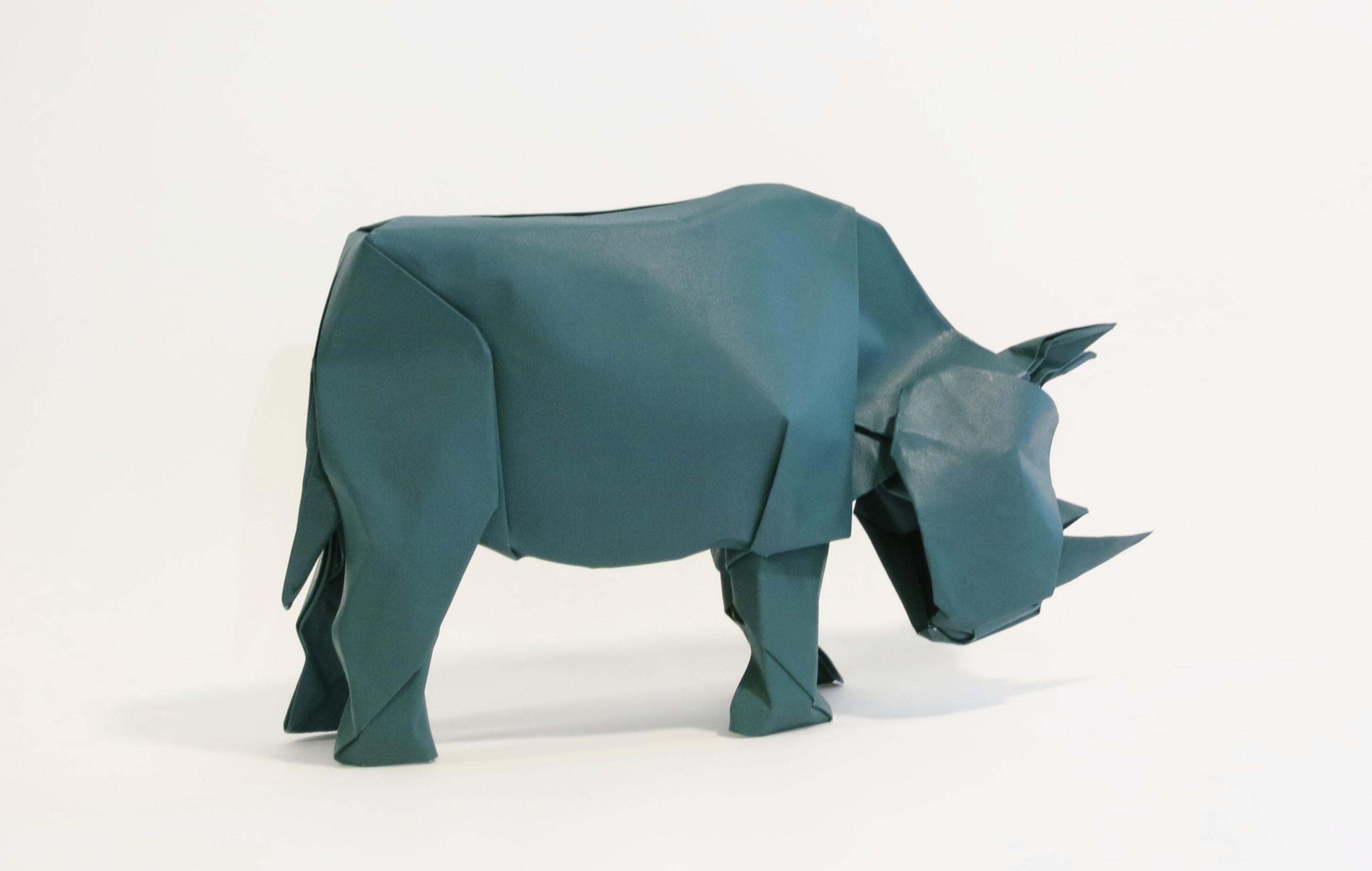 Origami rhino made of teal paper HD Wallpaper
