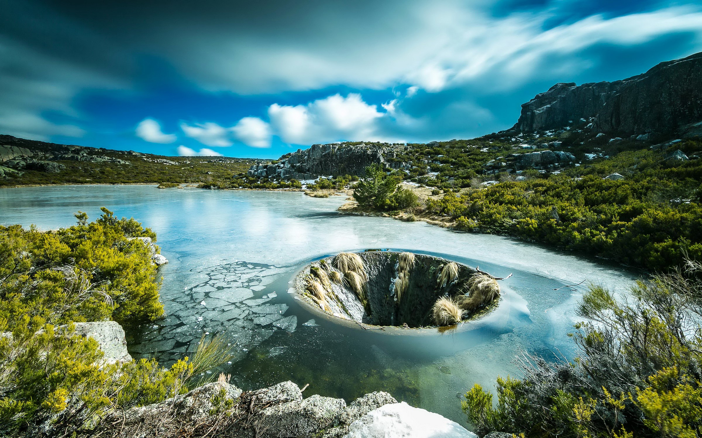 Frozen lake with a sinkhole in Sabugueiro, Portugal HD Wallpaper