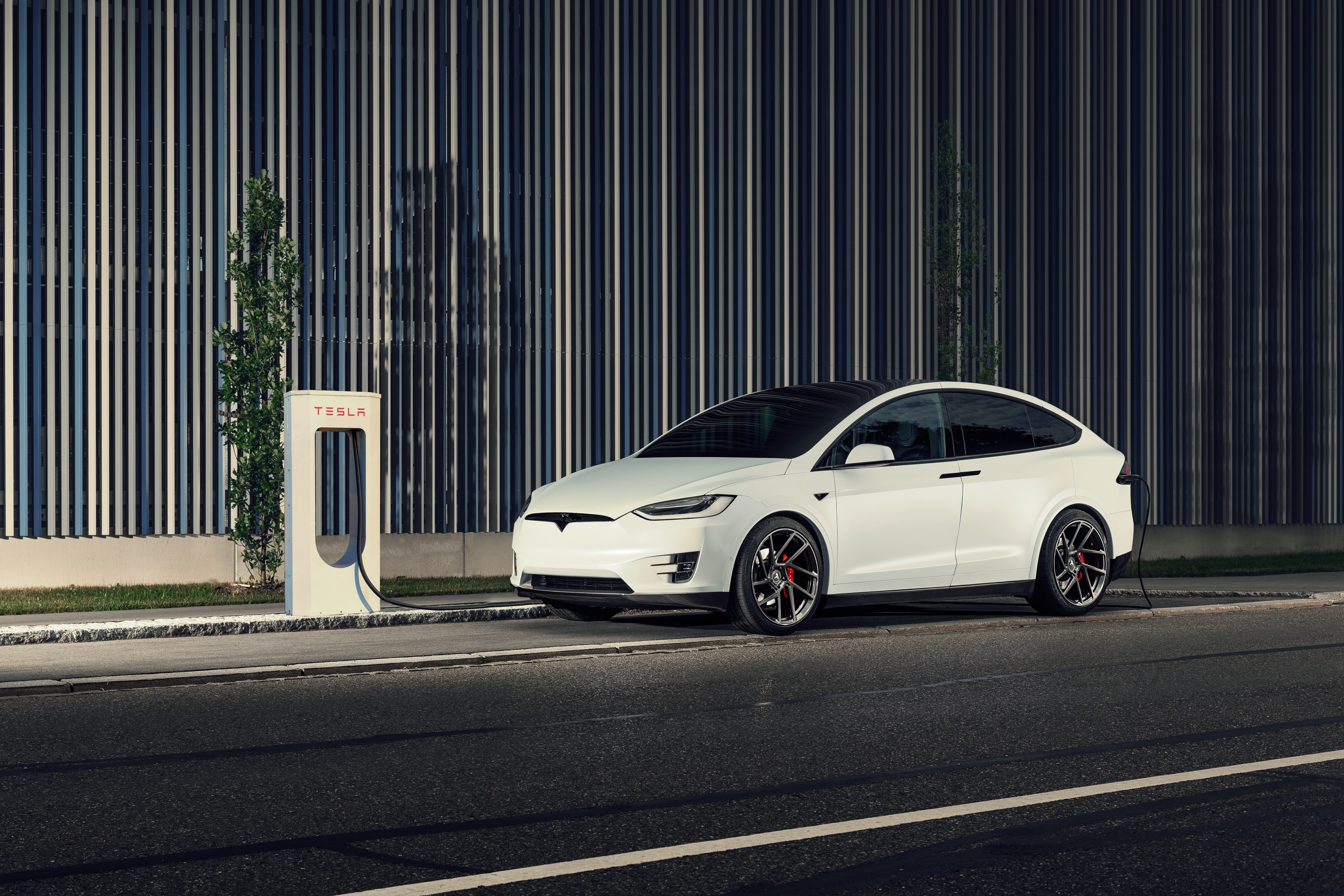 White Tesla Model X charging at Tesla station HD Wallpaper
