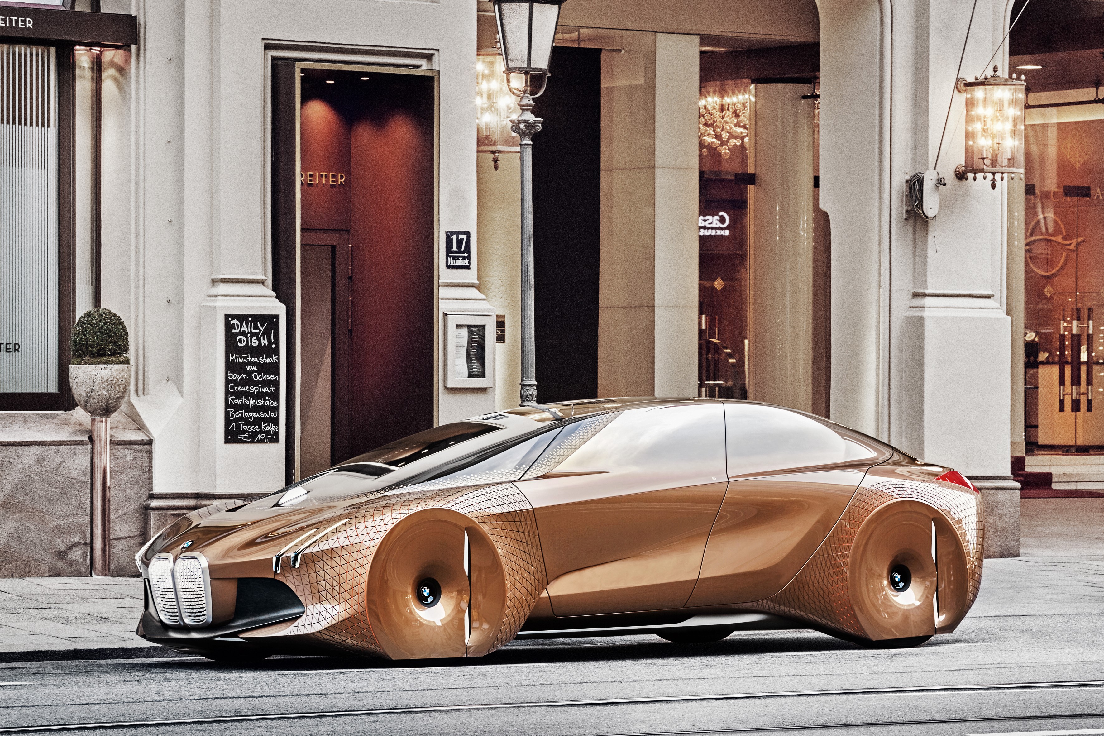 BMW Vision Next 100 concept car on a city street HD Wallpaper