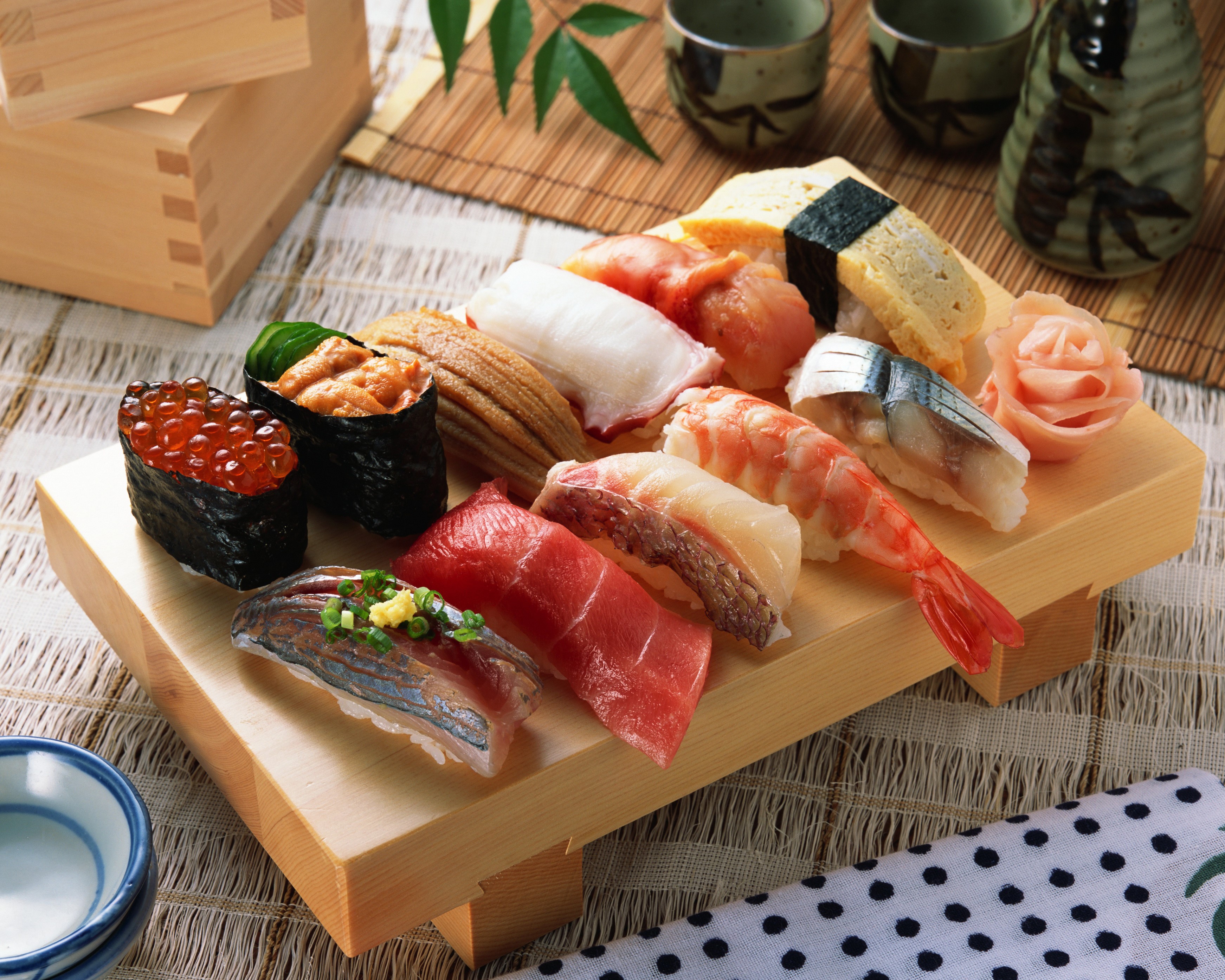 Assortment of sushi on a wooden platter HD Wallpaper