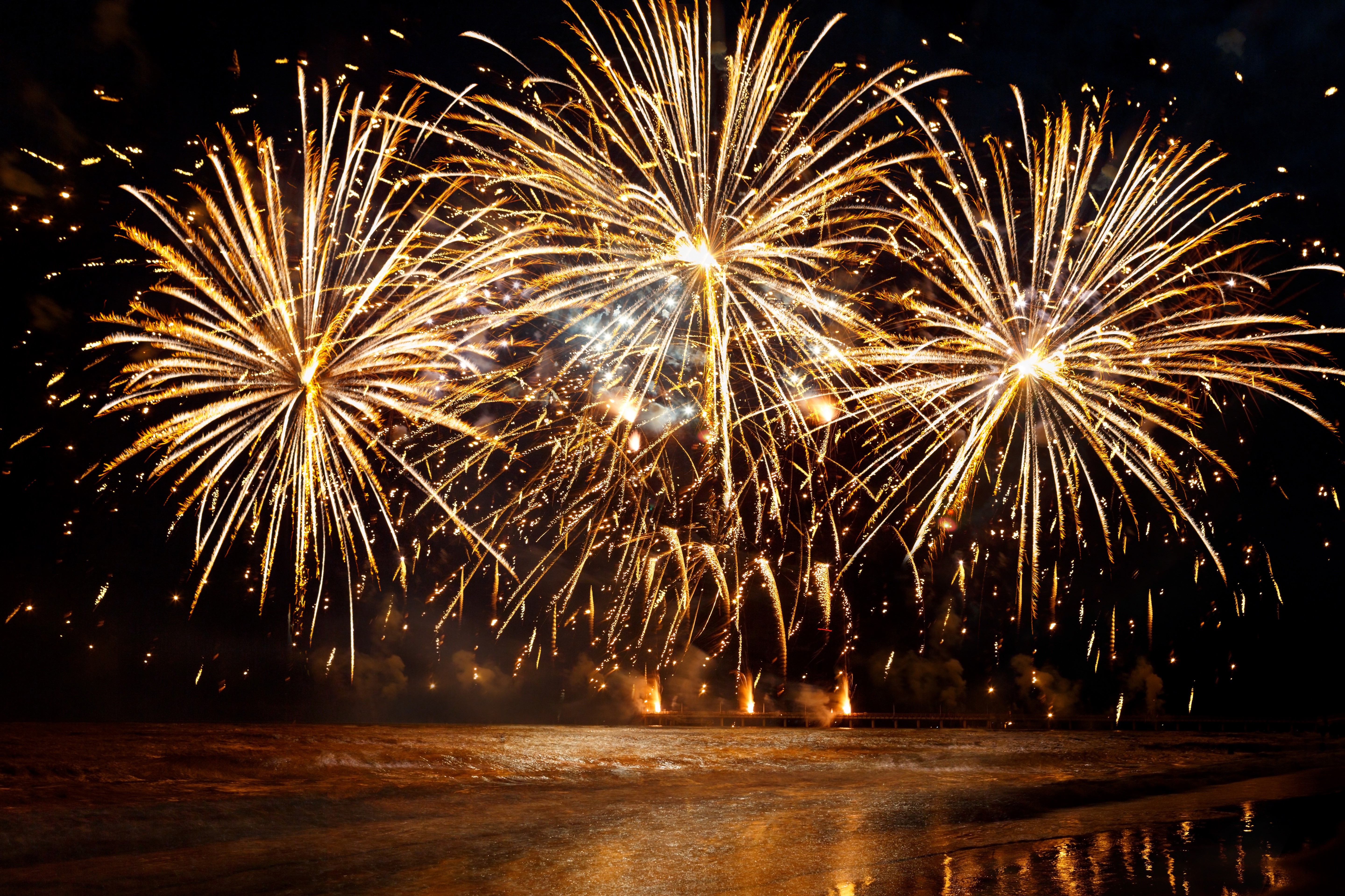 Golden Fireworks Over the Ocean HD Wallpaper