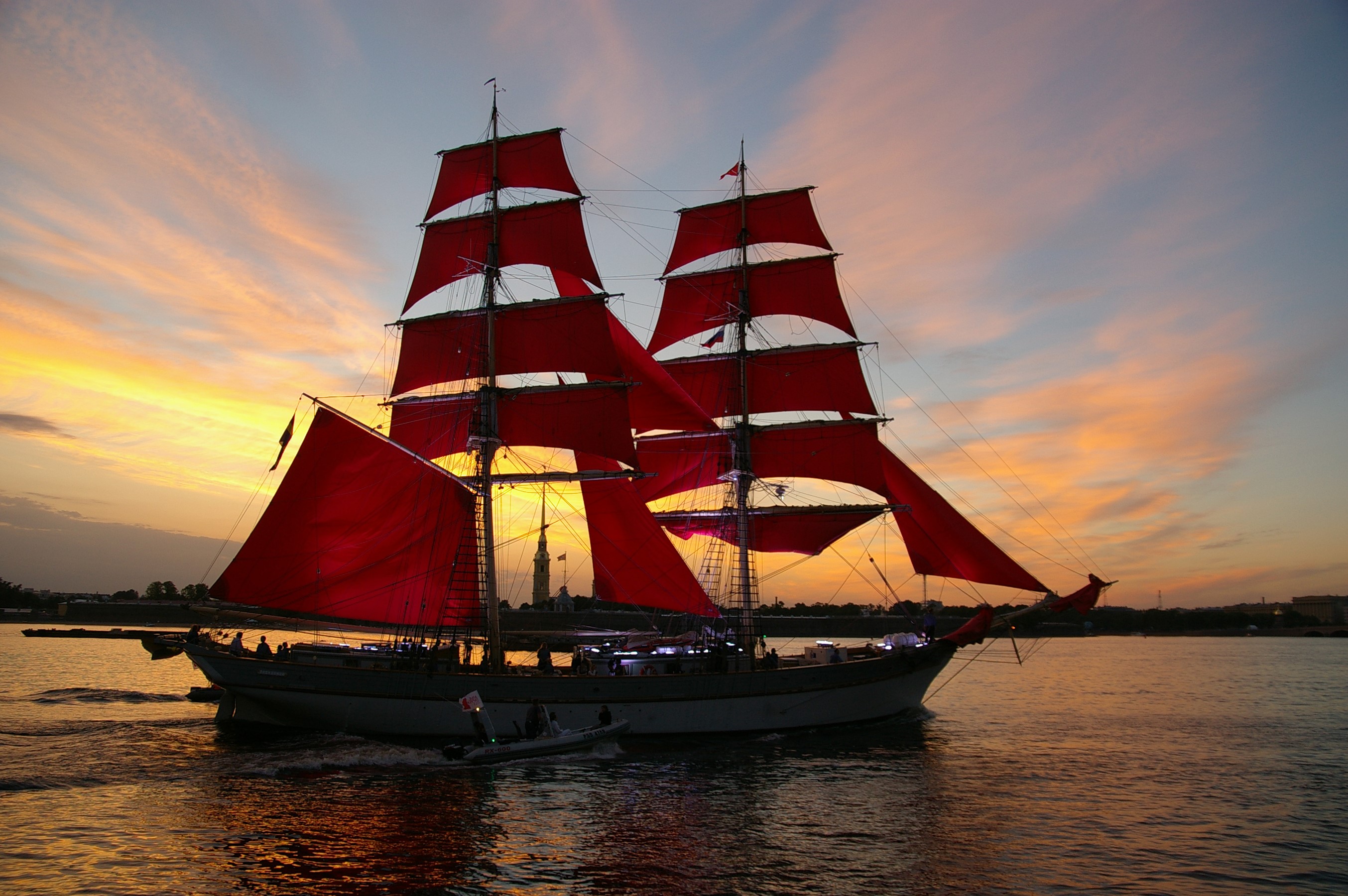Sailing ship with red sails on a river at sunset HD Wallpaper