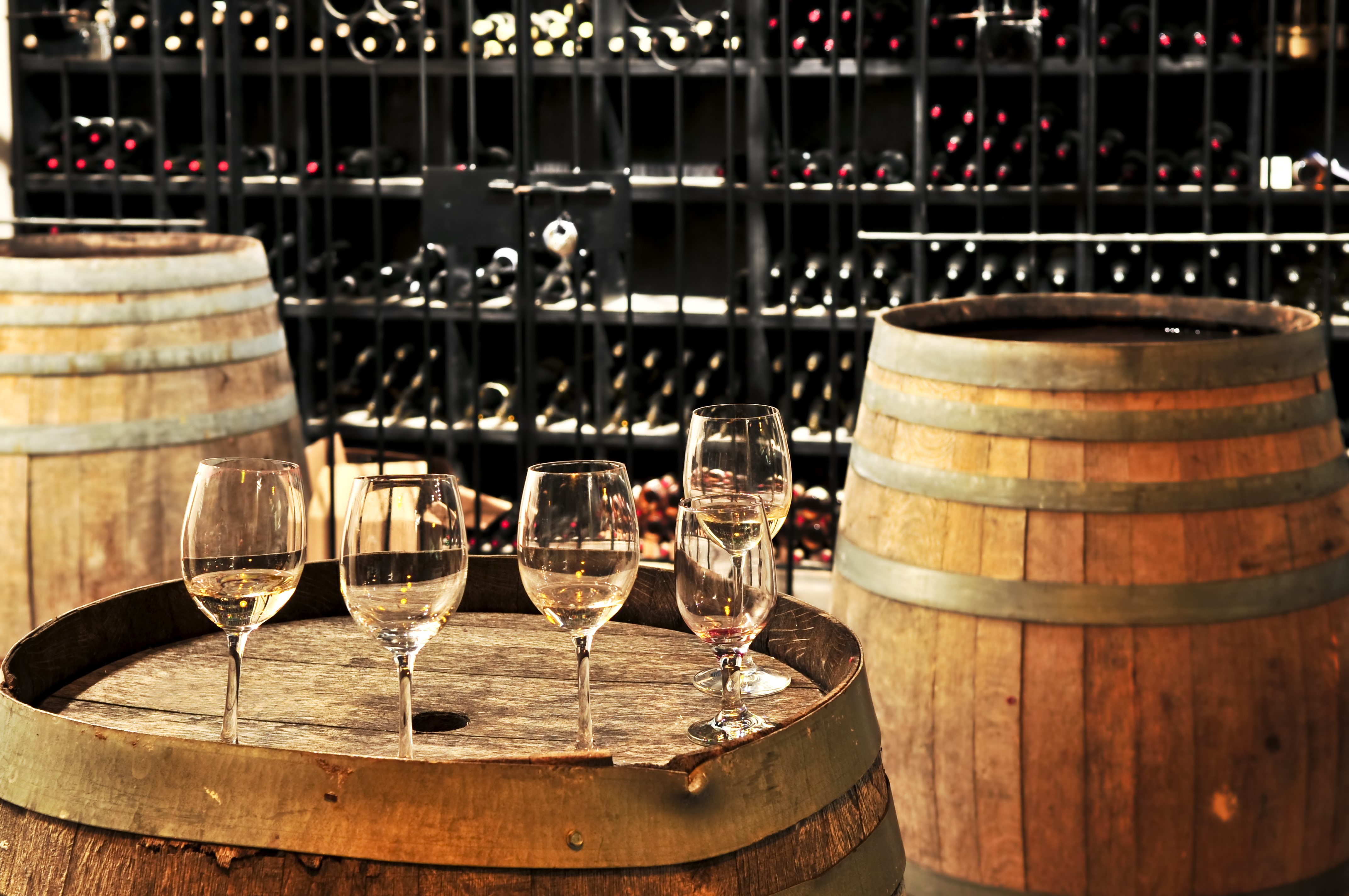 Wine barrels and glasses in a cellar HD Wallpaper
