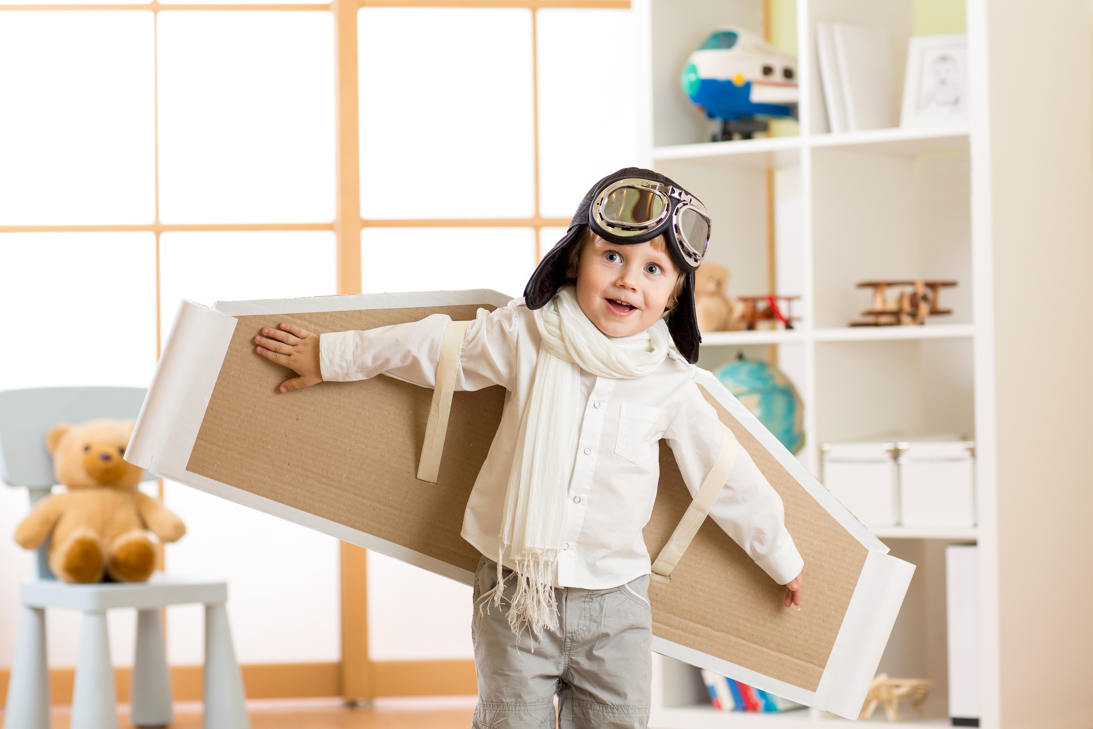 Boy with Cardboard Airplane Wings and Goggles HD Wallpaper