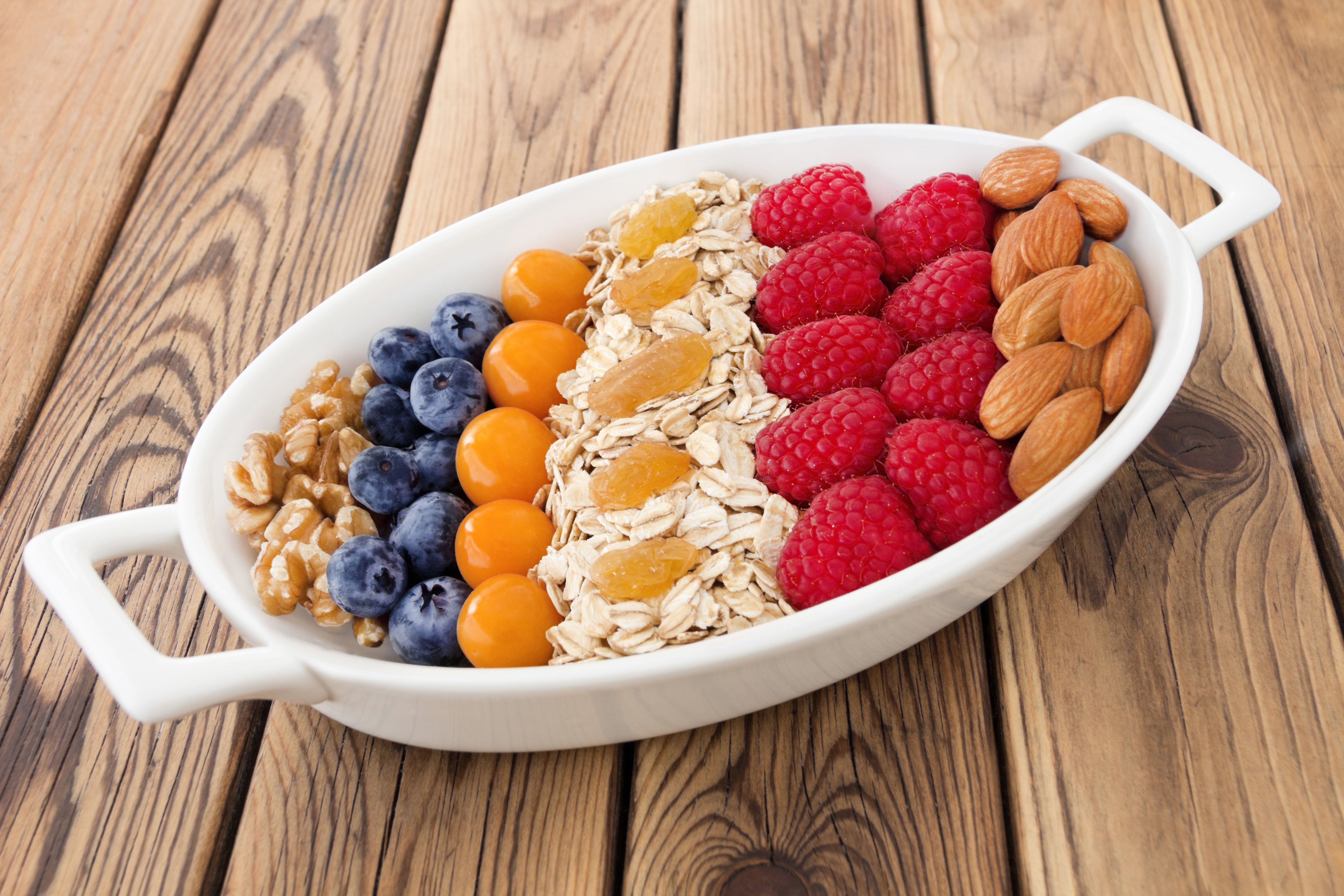 Muesli with Raspberries, Blueberries, Nuts, and Dried Fruit HD Wallpaper