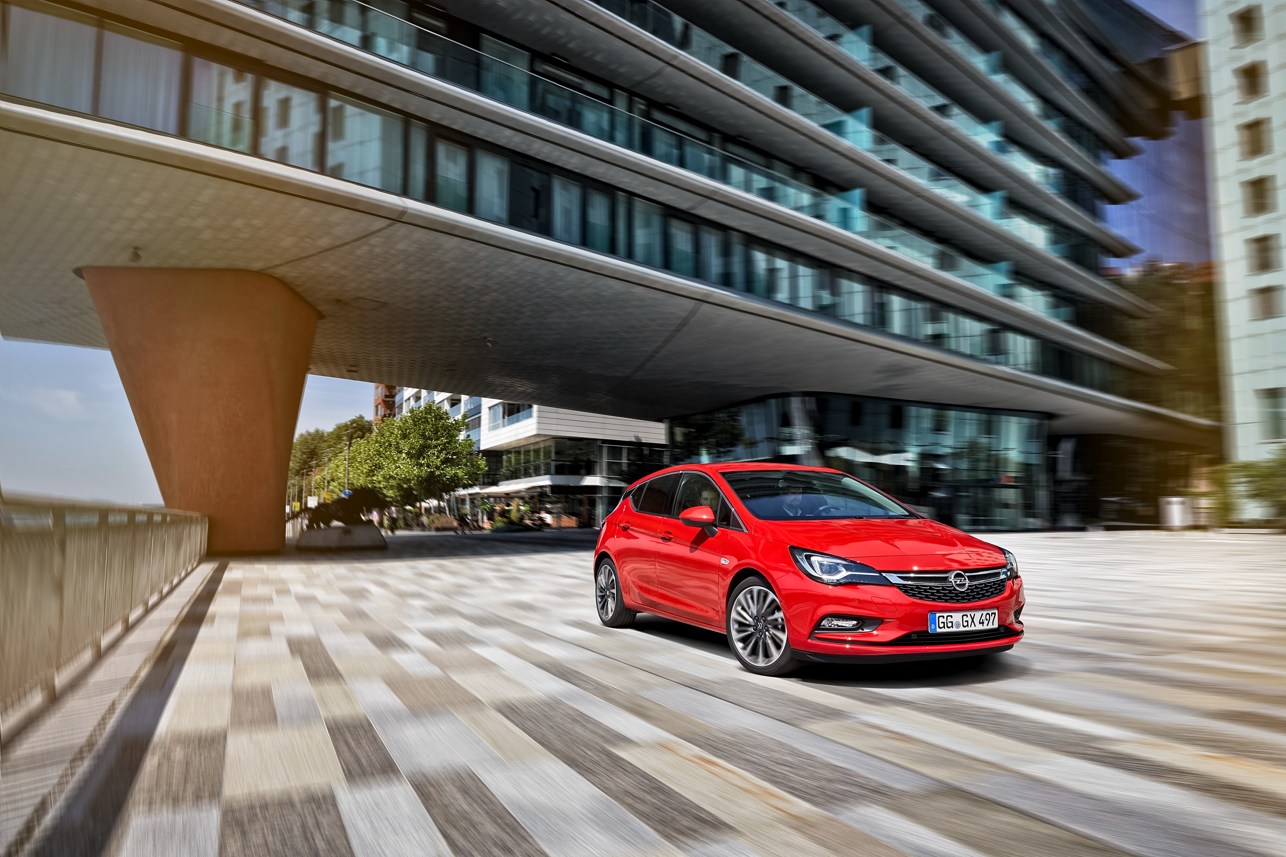 Red 2015 Opel Astra K driving on city street HD Wallpaper