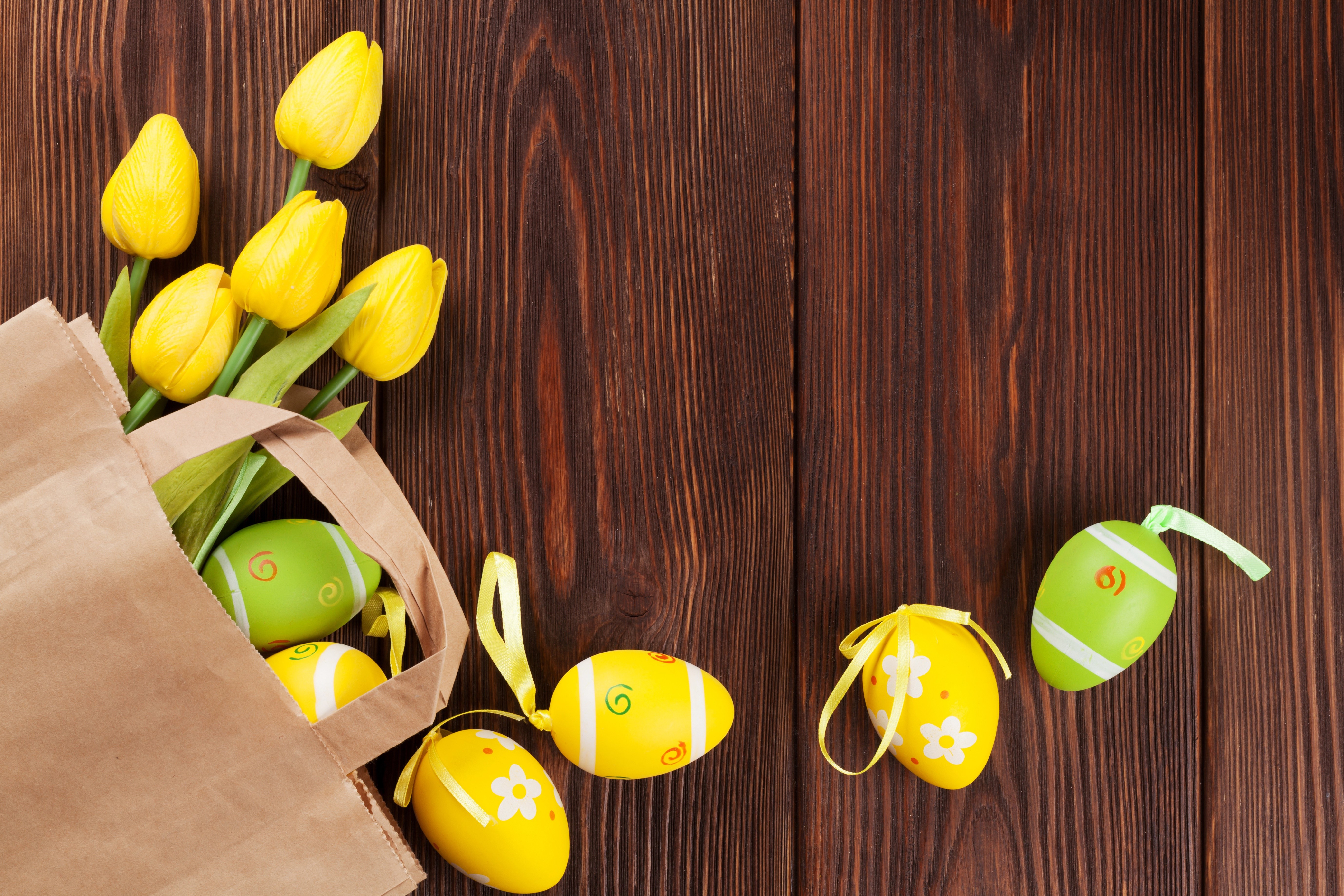 Yellow Tulips and Easter Eggs in a Paper Bag on Wood HD Wallpaper