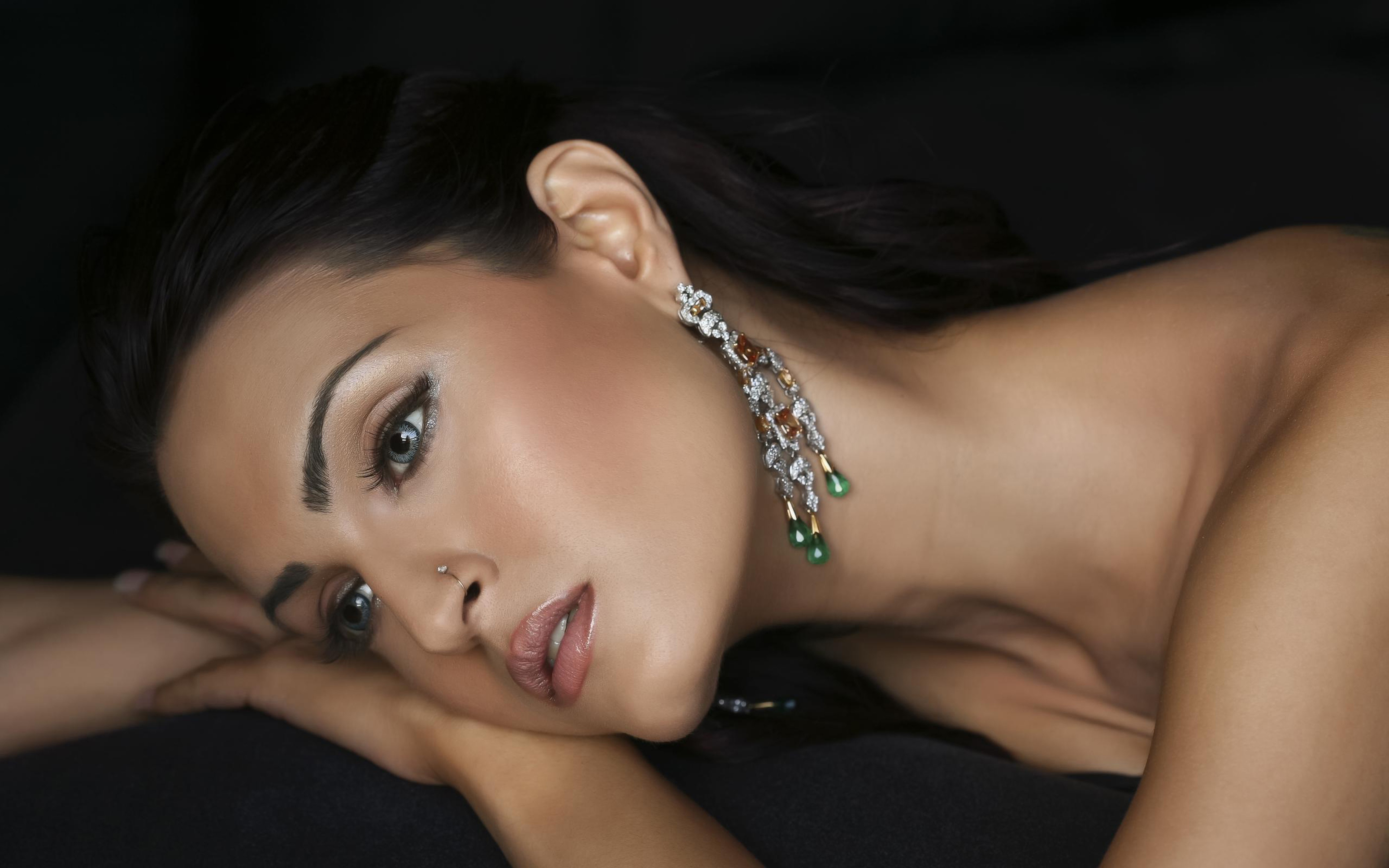 Woman with elaborate earrings and makeup HD Wallpaper