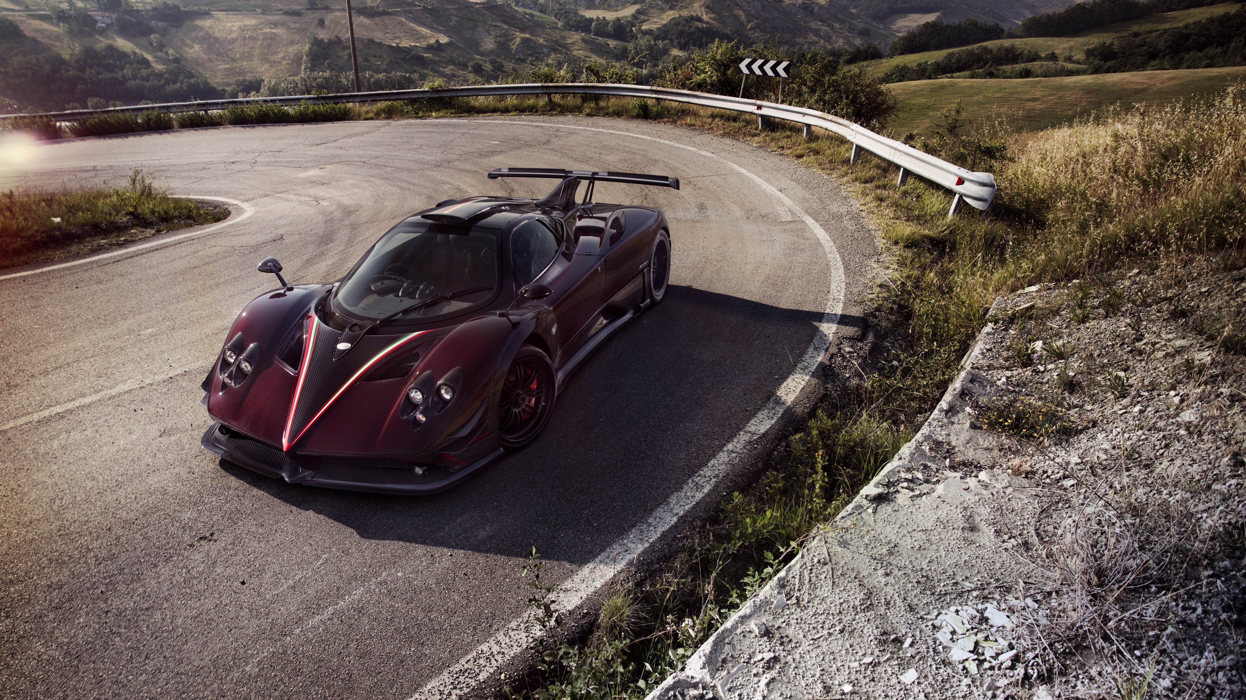 4K Wine color Pagani Zonda Fantasma Evo on a winding road HD Wallpaper