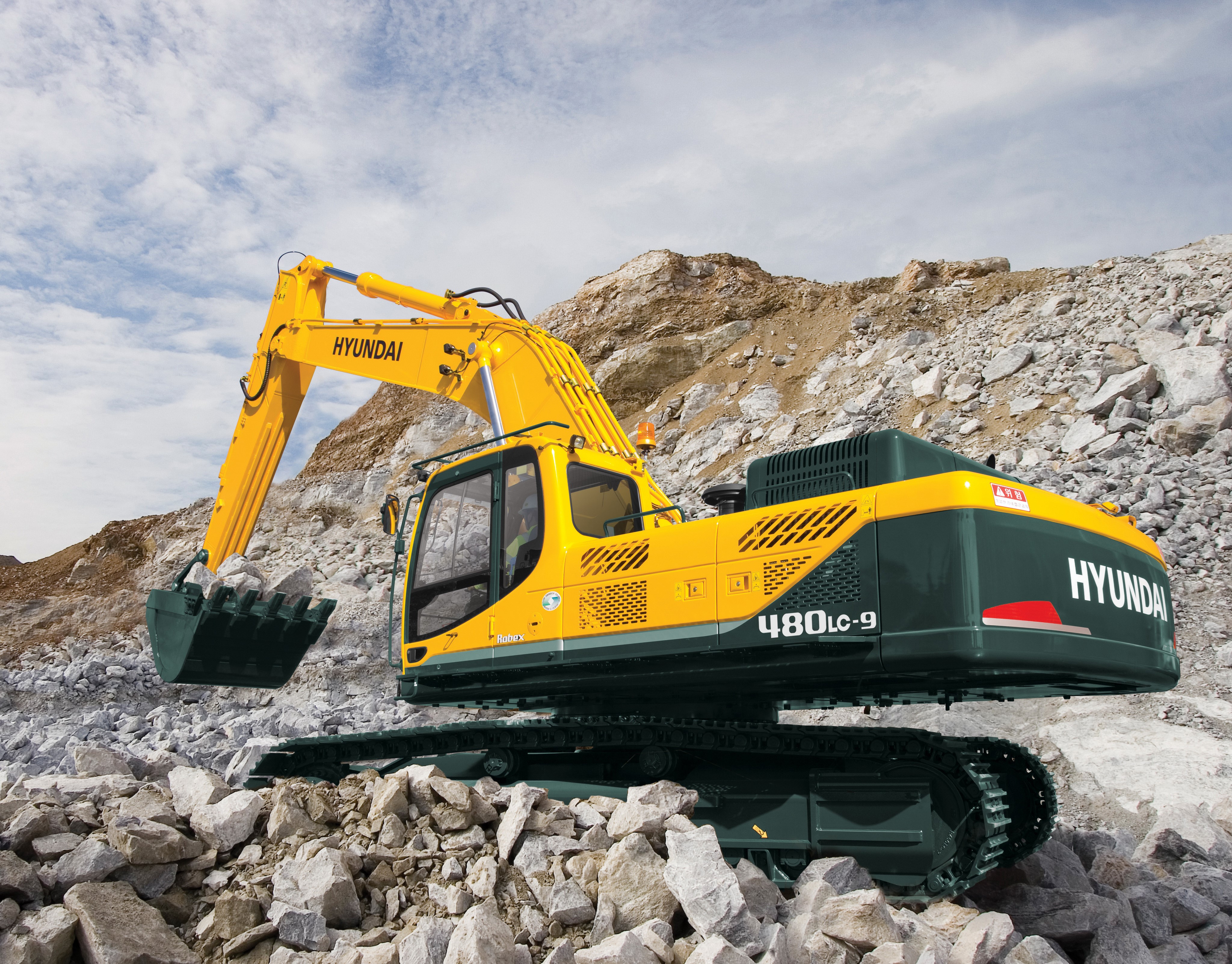4K Hyundai R480LC-9 Excavator on Rocky Terrain HD Wallpaper