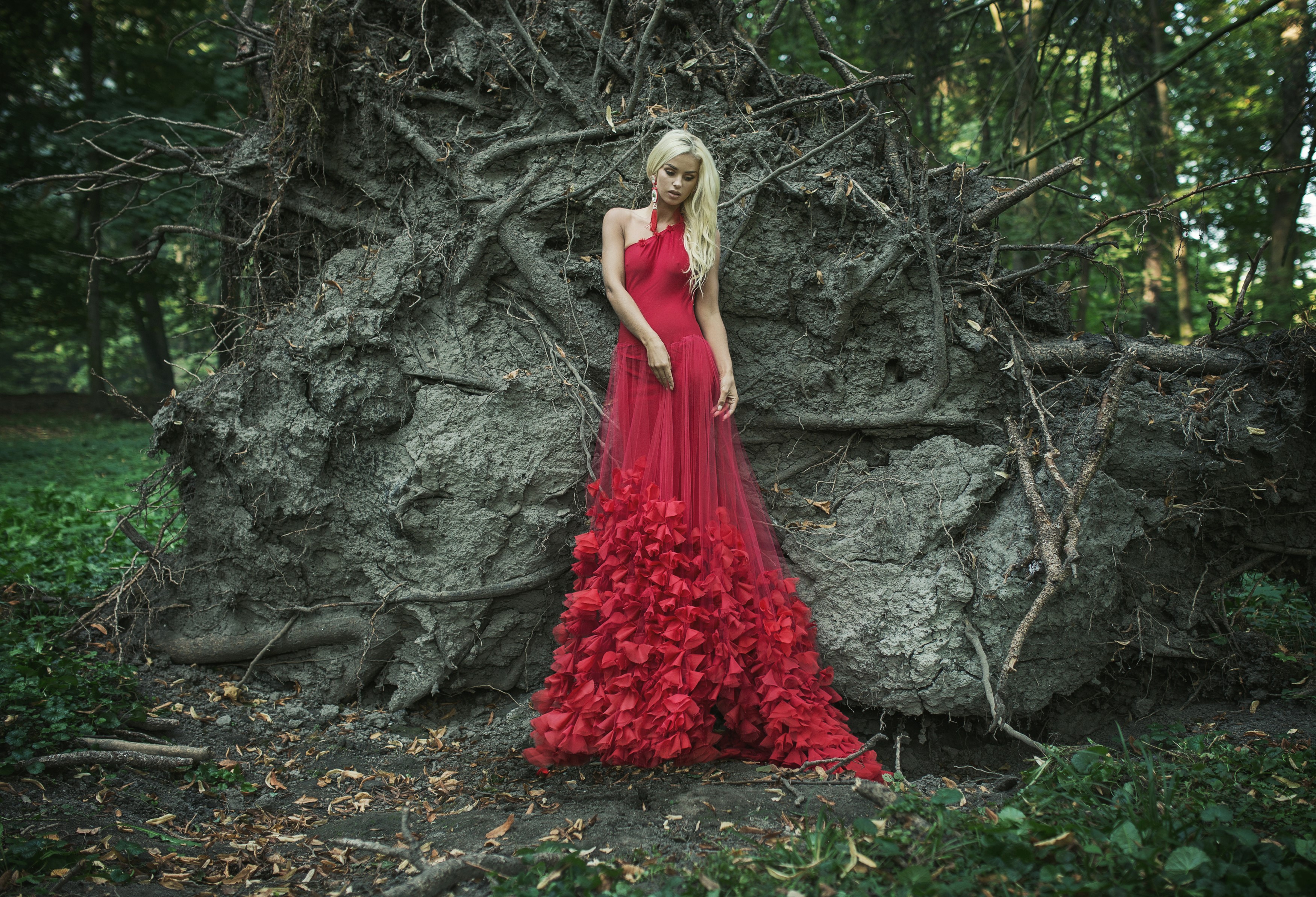 Blonde girl in a red dress near a fallen tree HD Wallpaper