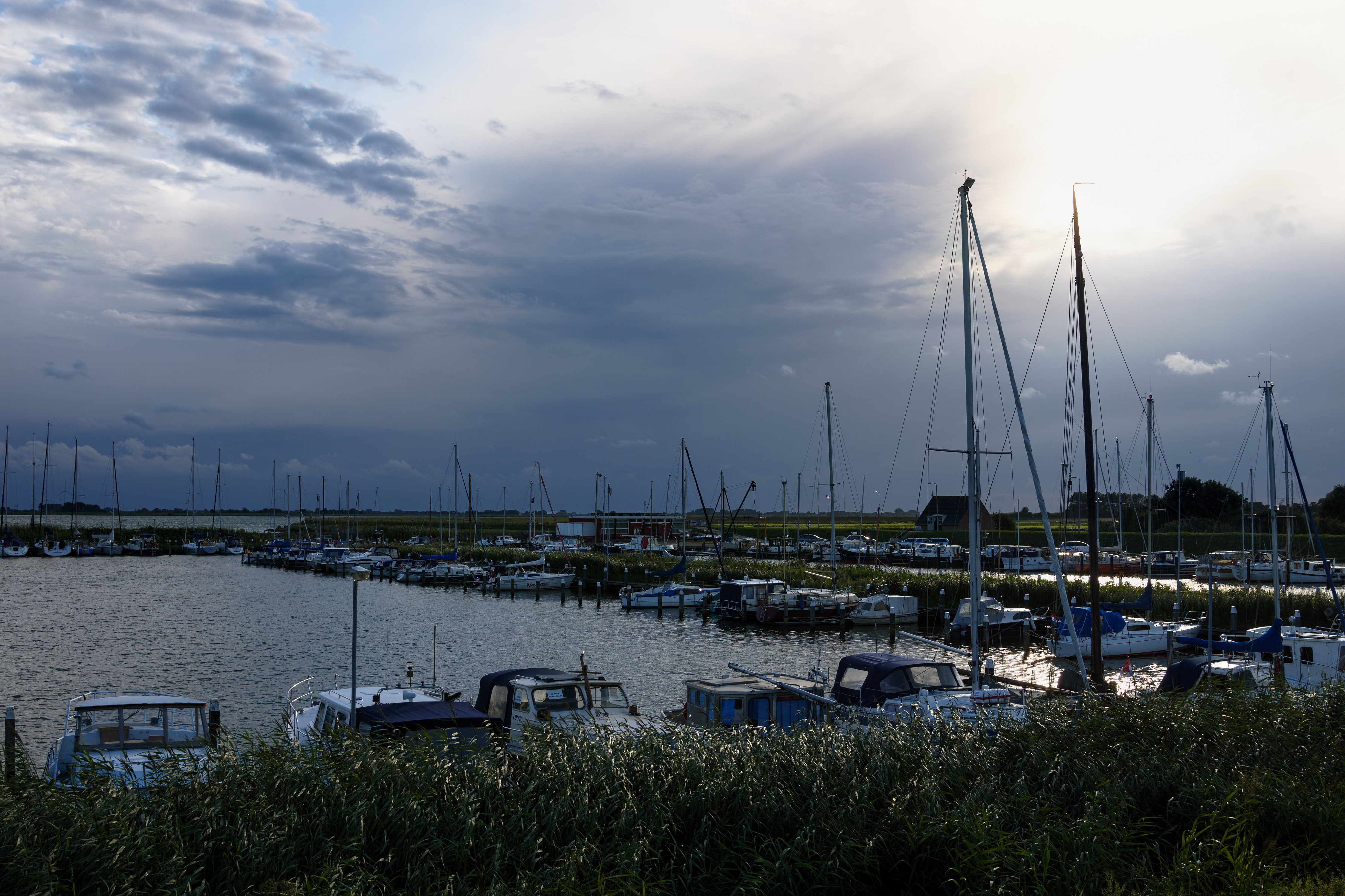 Boats docked at Amstelmeer marina in the Netherlands at dusk HD Wallpaper