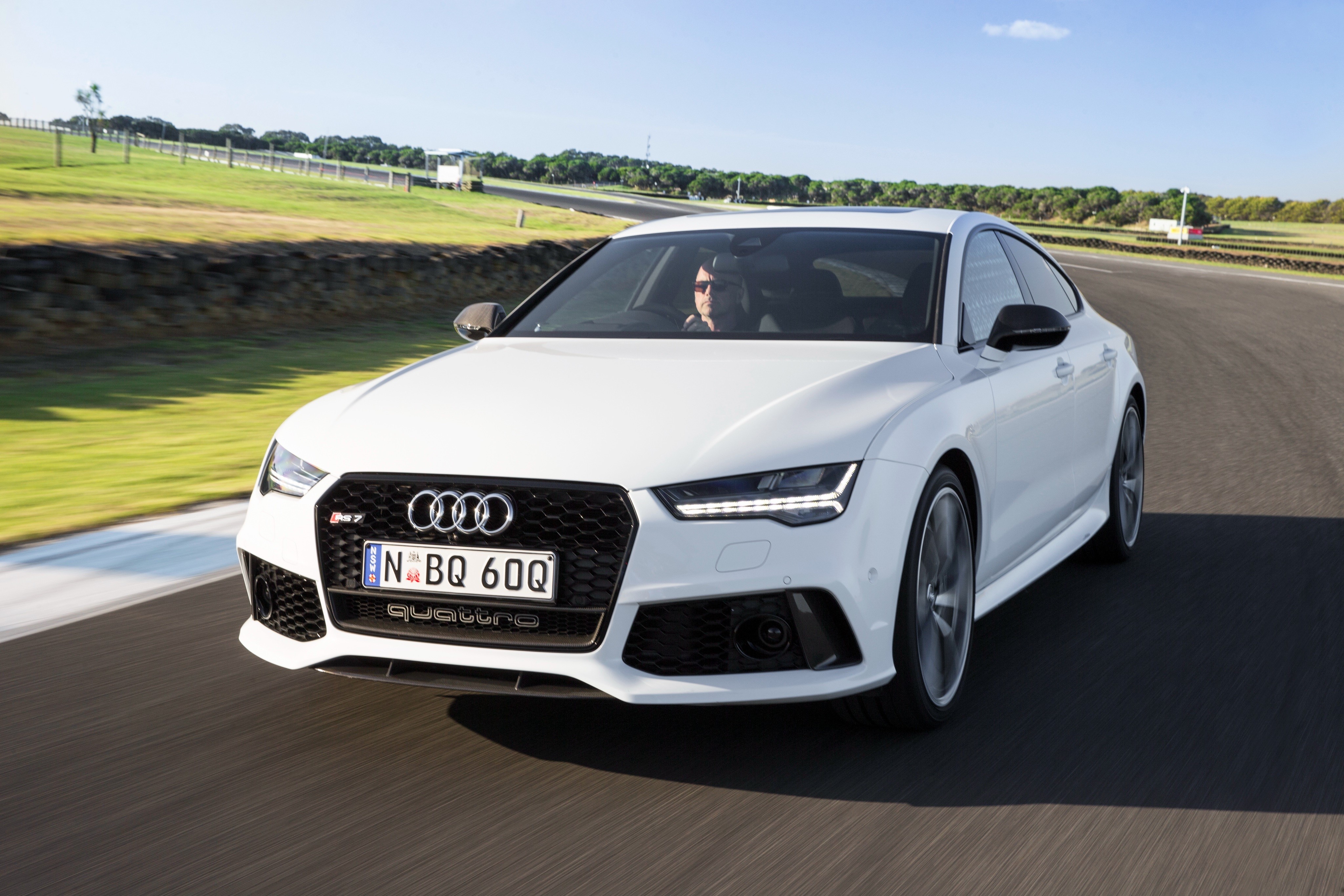 White Audi RS 7 Sportback performance on a racetrack HD Wallpaper