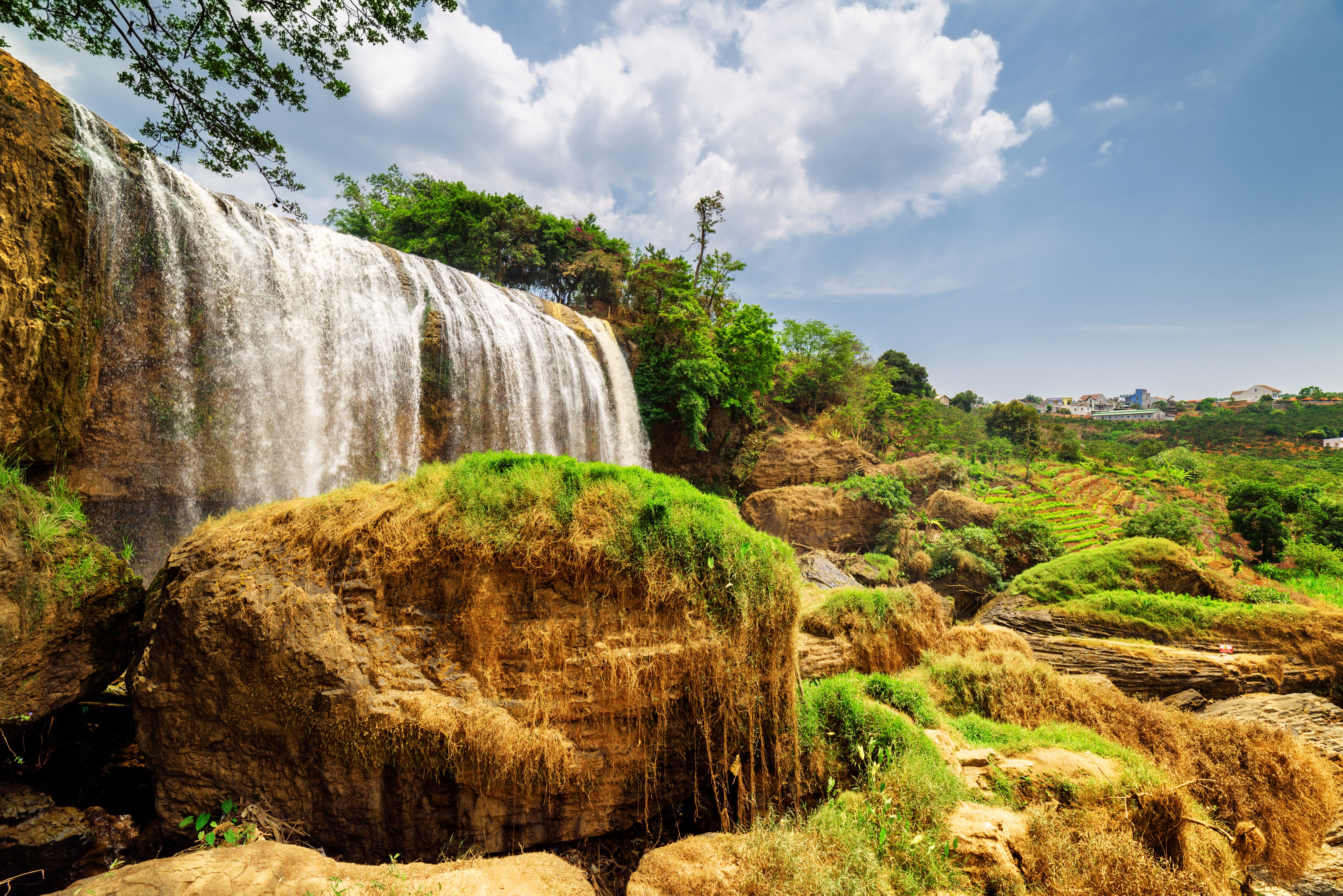 Waterfall in Vietnam with green terraces and houses HD Wallpaper