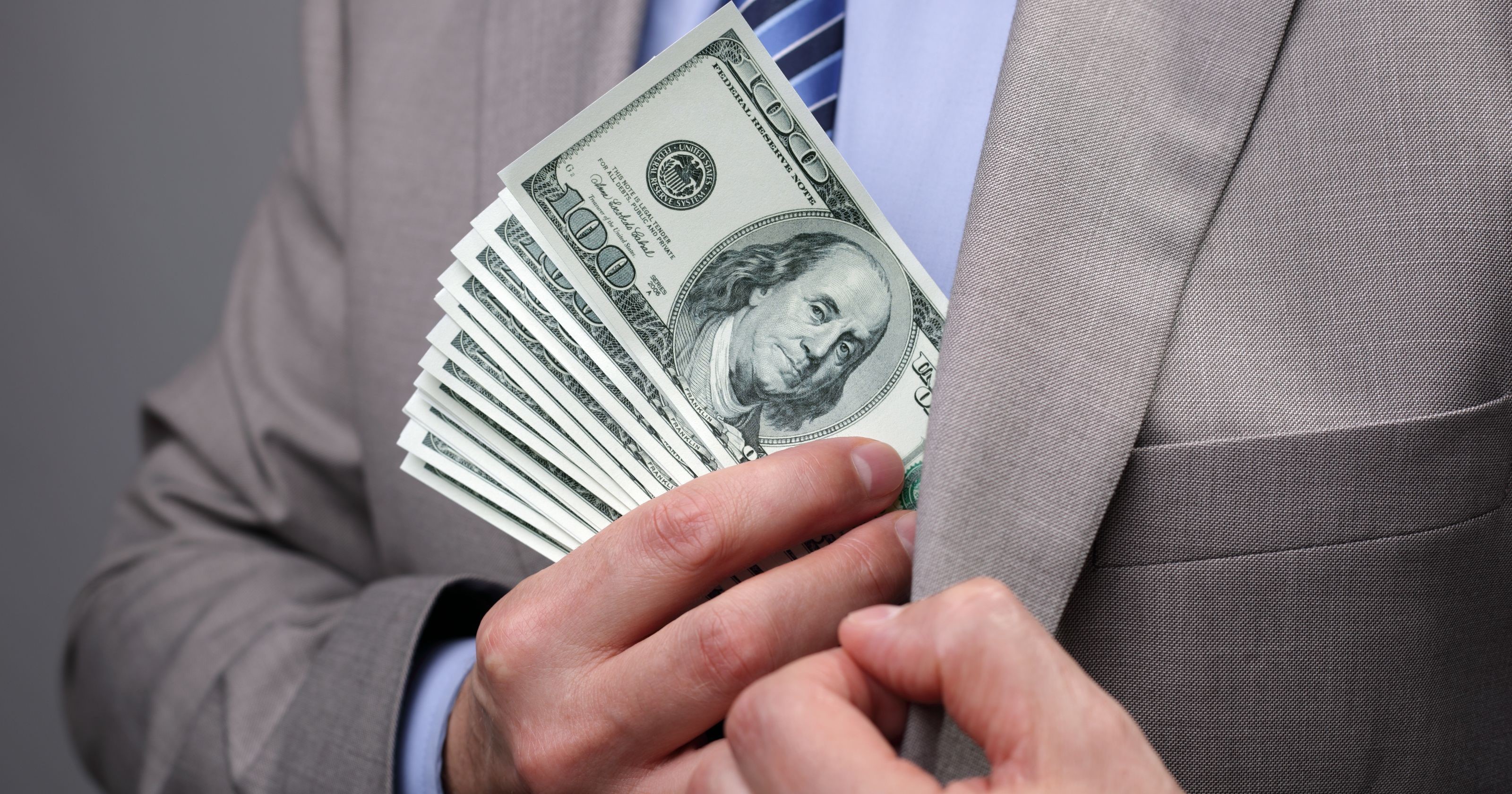Man in Suit Hiding Money in Pocket HD Wallpaper