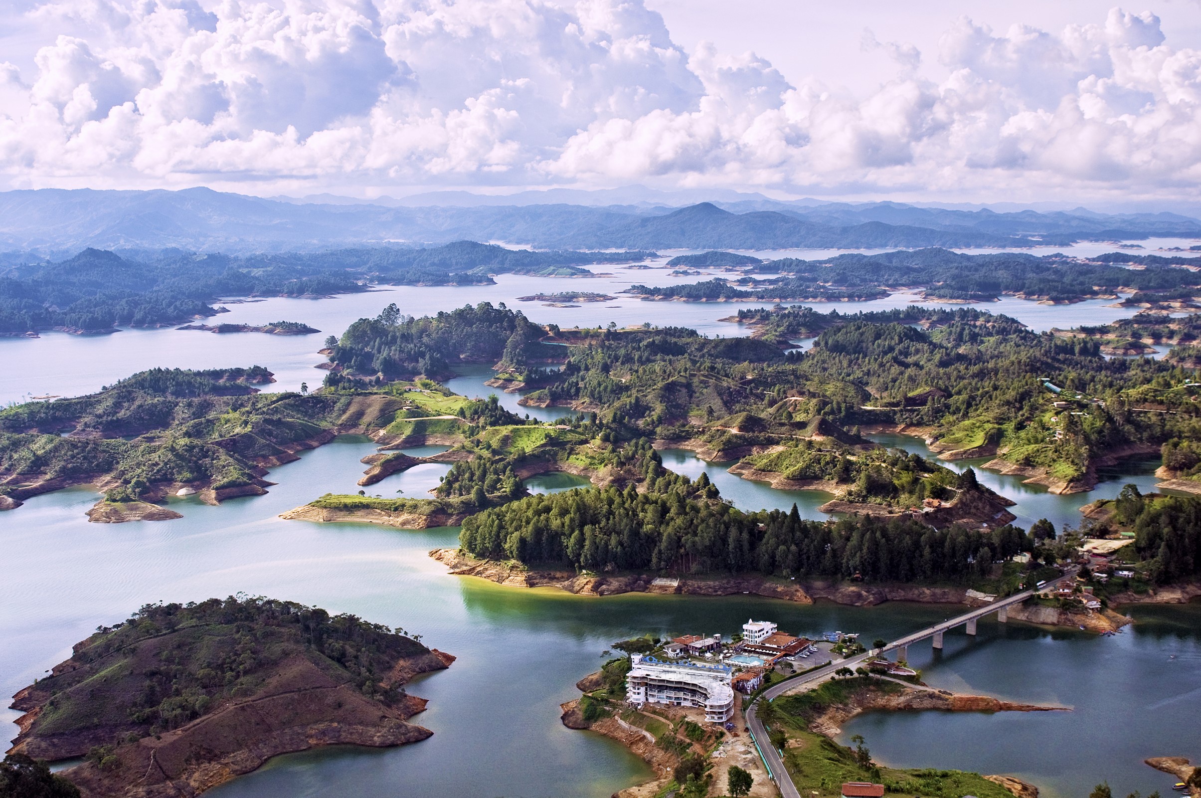 Aerial view of a lake with many islands and a bridge HD Wallpaper
