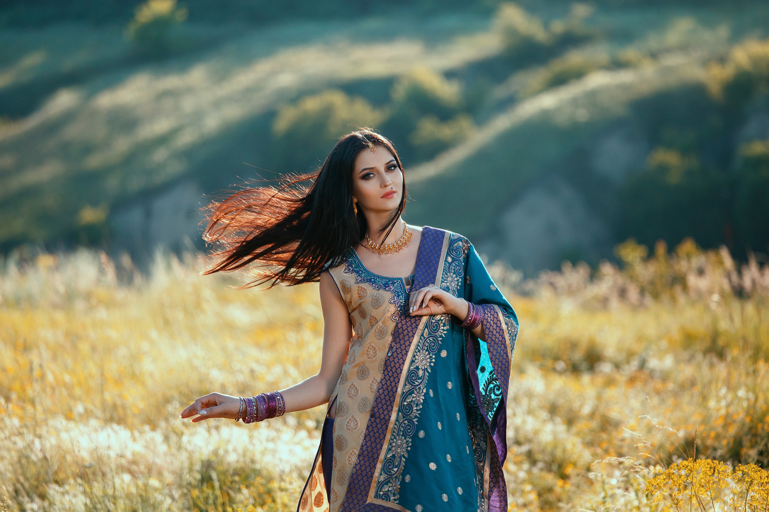 Brunette woman in traditional Indian attire in a field HD Wallpaper