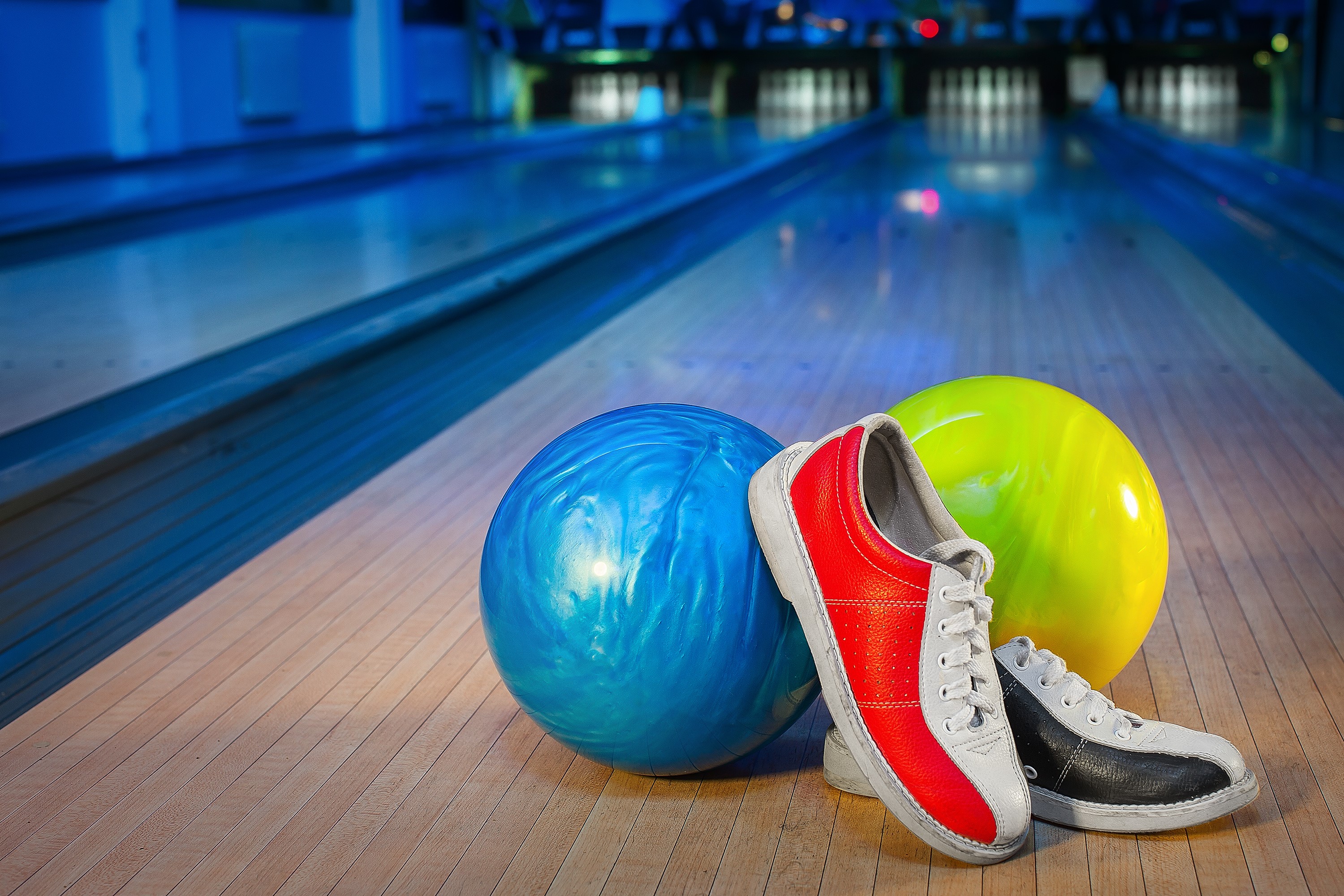 Bowling balls and shoes on a lane HD Wallpaper