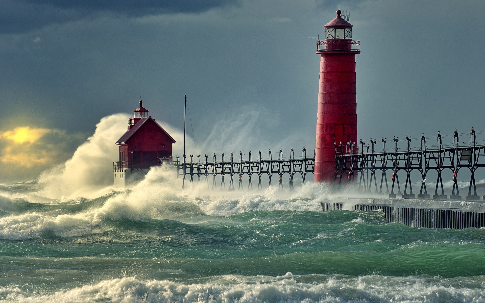 Two red lighthouses on a pier during a storm HD Wallpaper
