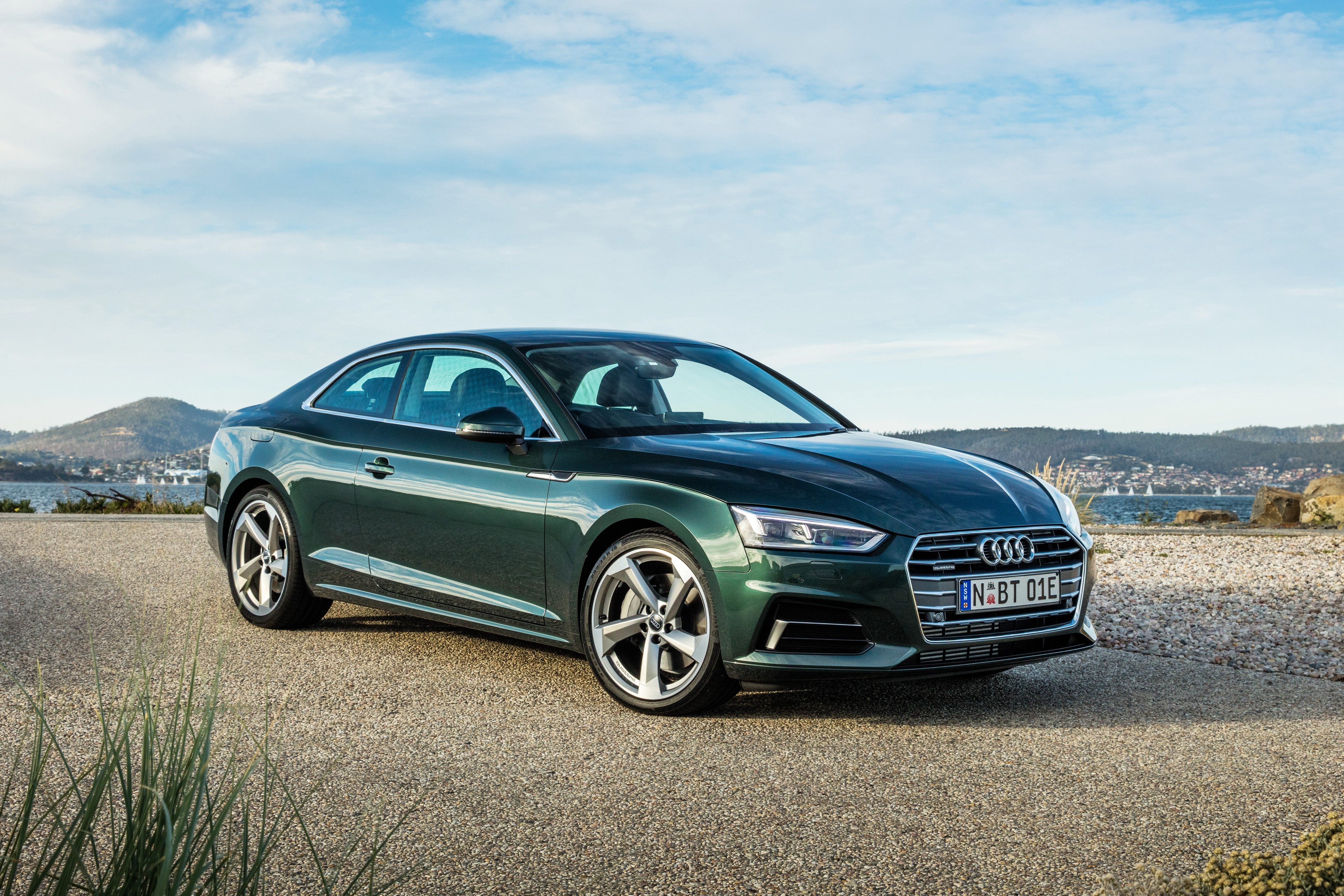 Green Audi A5 Coupe on a gravel road HD Wallpaper