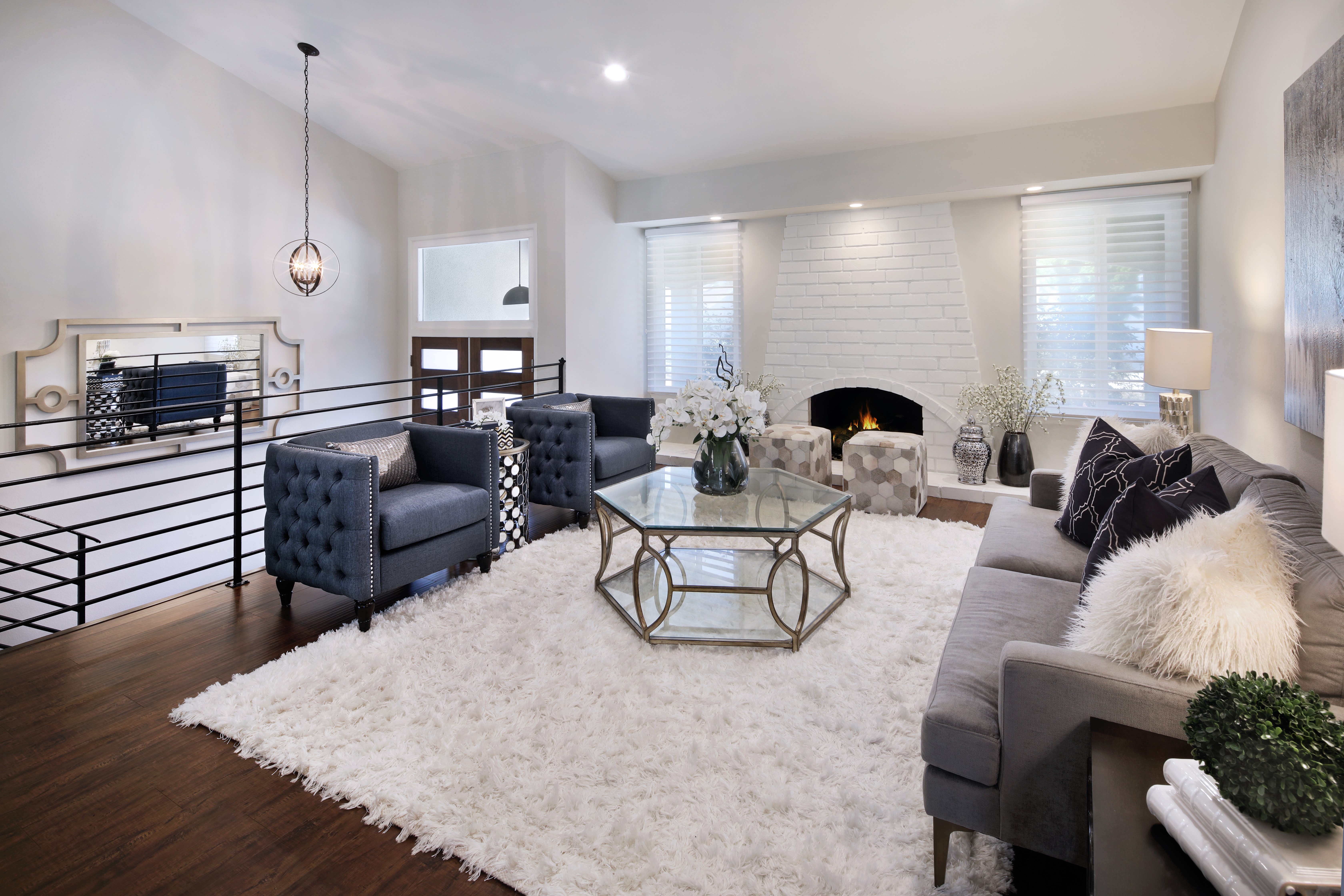 Living room with sofa, armchairs, and fireplace HD Wallpaper