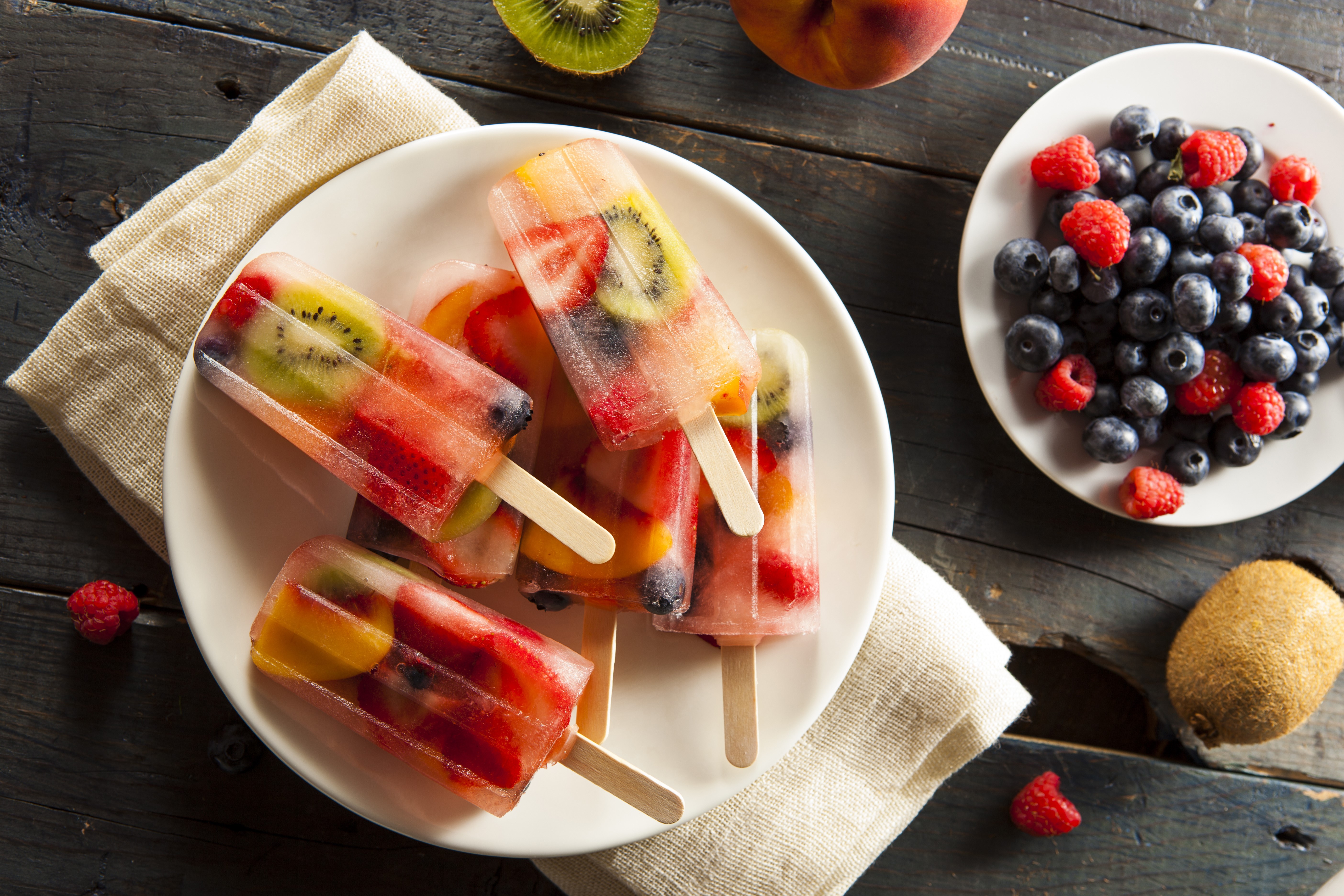 Fruit popsicles with berries and kiwi on a plate HD Wallpaper