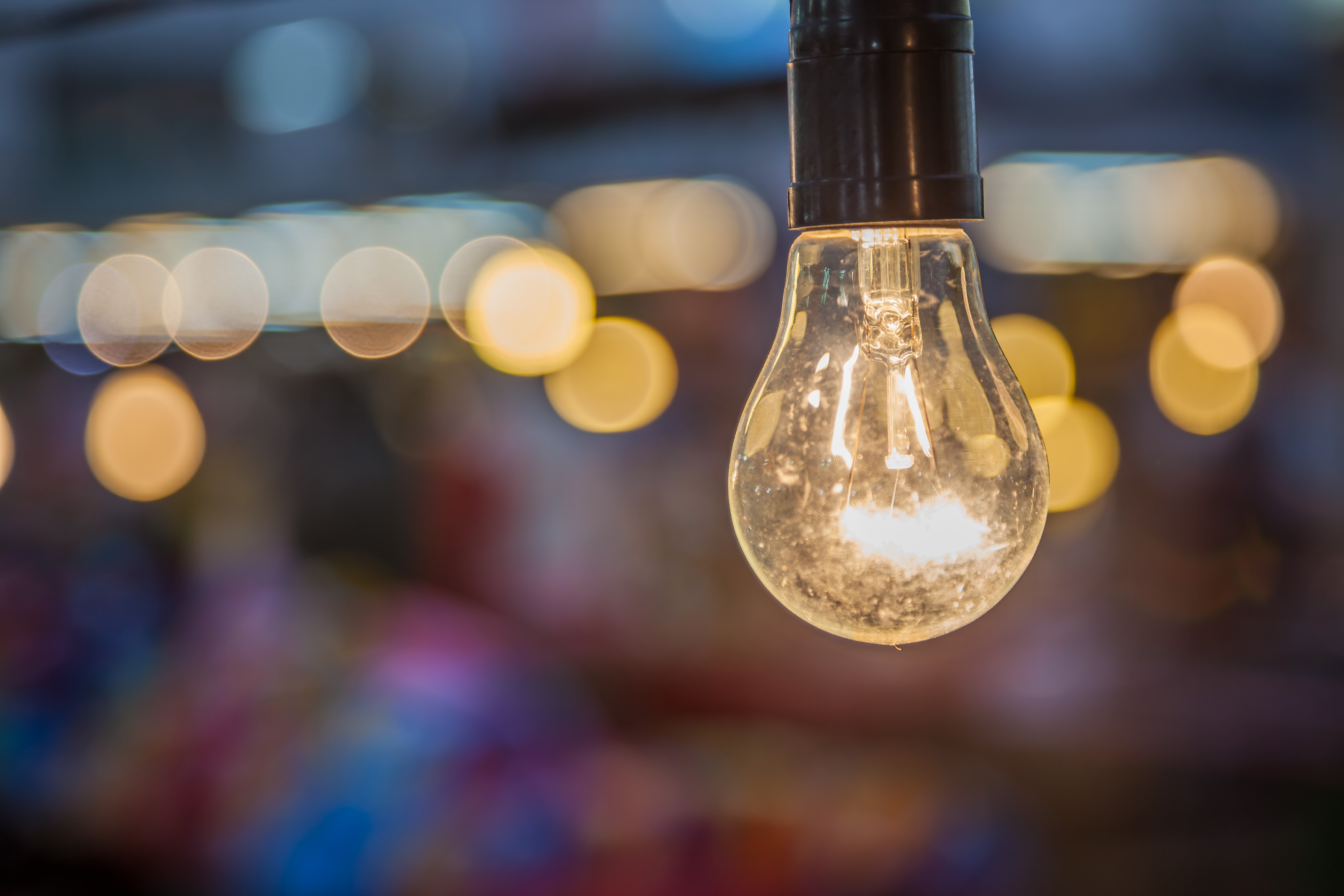 Close-up of a lit incandescent light bulb HD Wallpaper