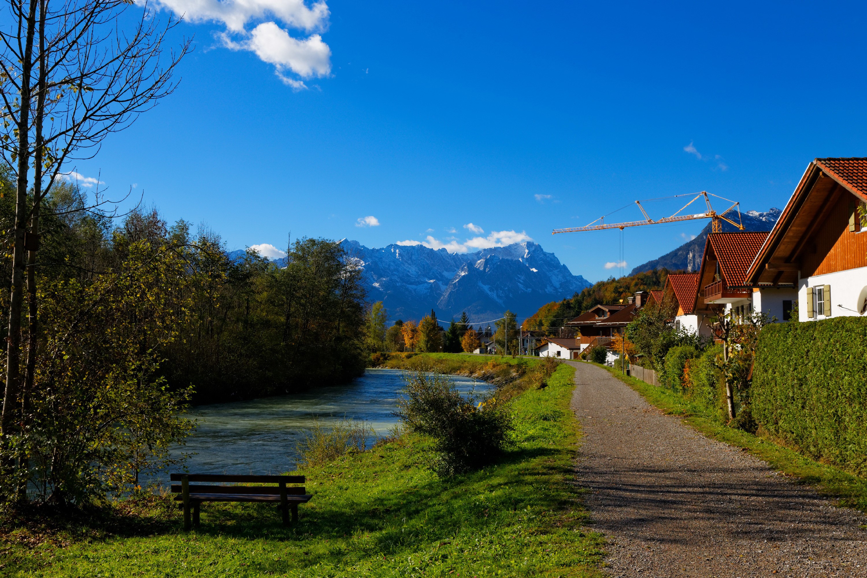 River and houses in Oberau, Germany with mountains HD Wallpaper