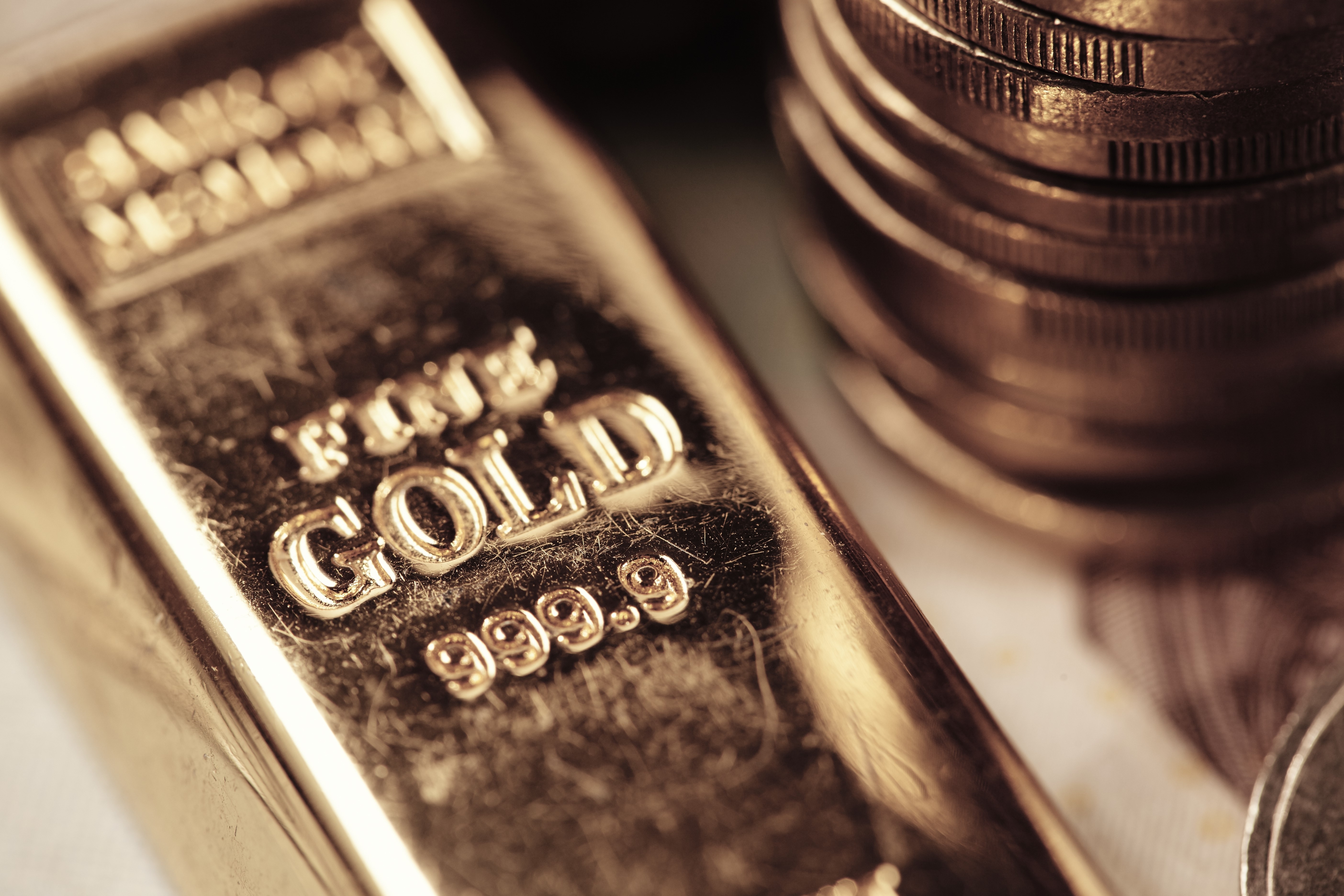 Gold ingot with 999.9 purity and stacked coins HD Wallpaper